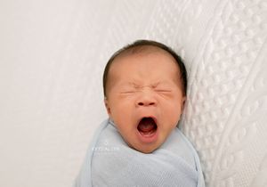 Tired baby doing a very big yawn