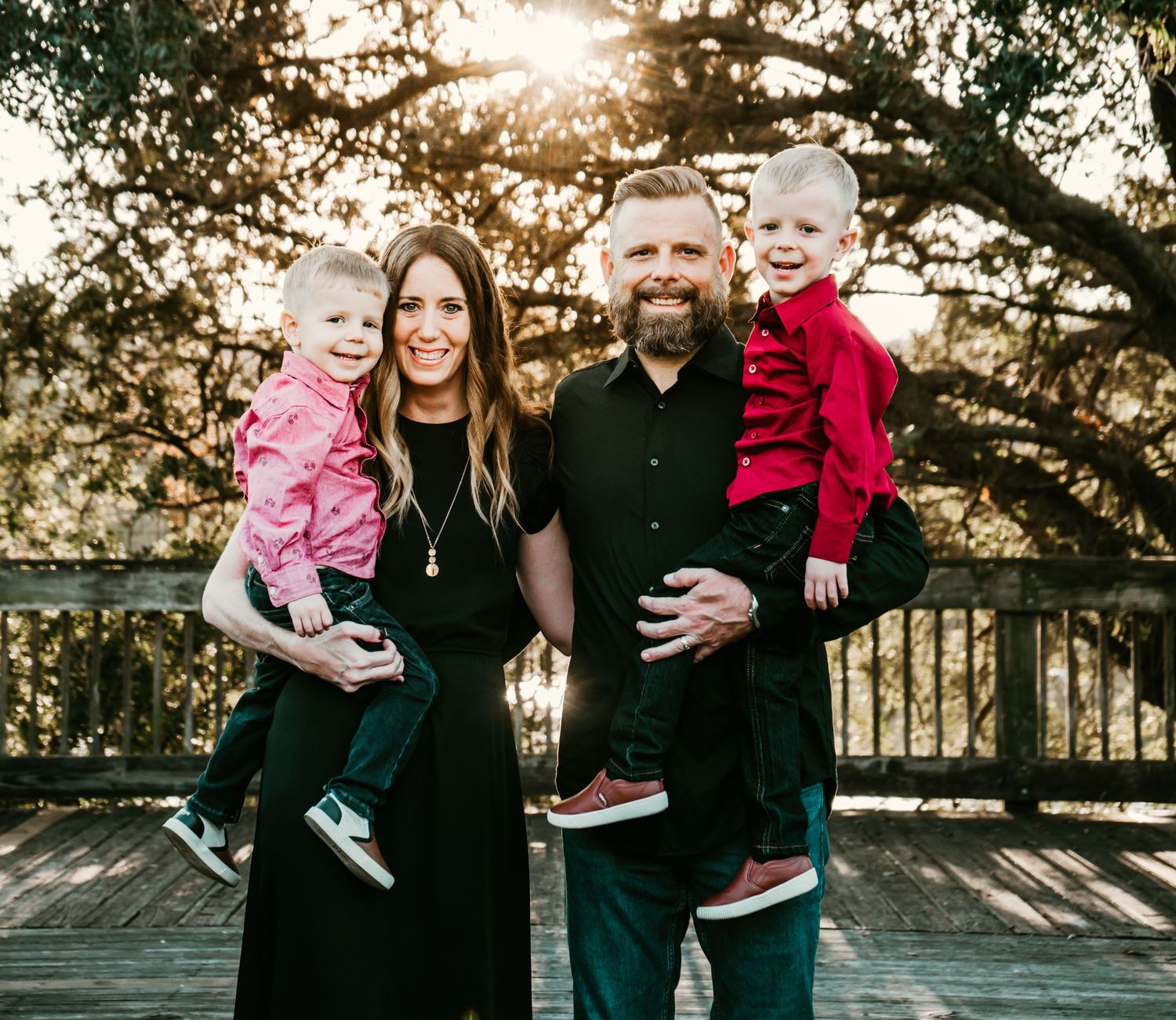 Eagle Lake Park in Clearwater, FL; Family posing on boardwalk at sunset