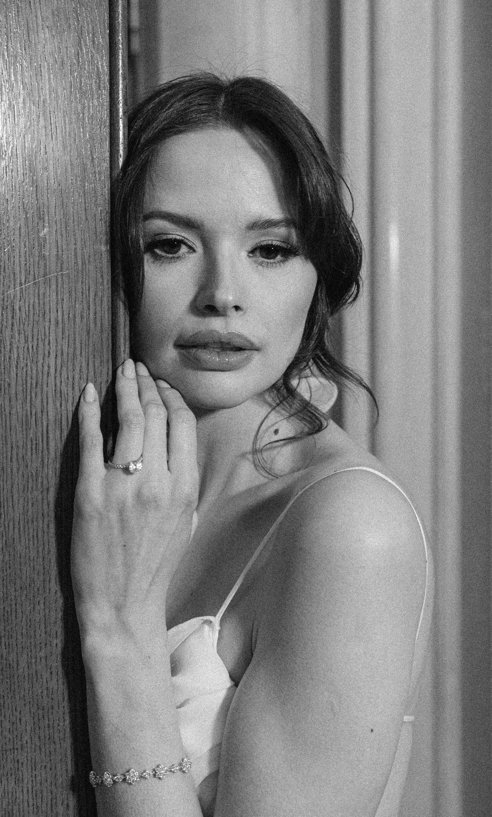 Classic black and white bridal portrait highlighting elegant jewelry and makeup.