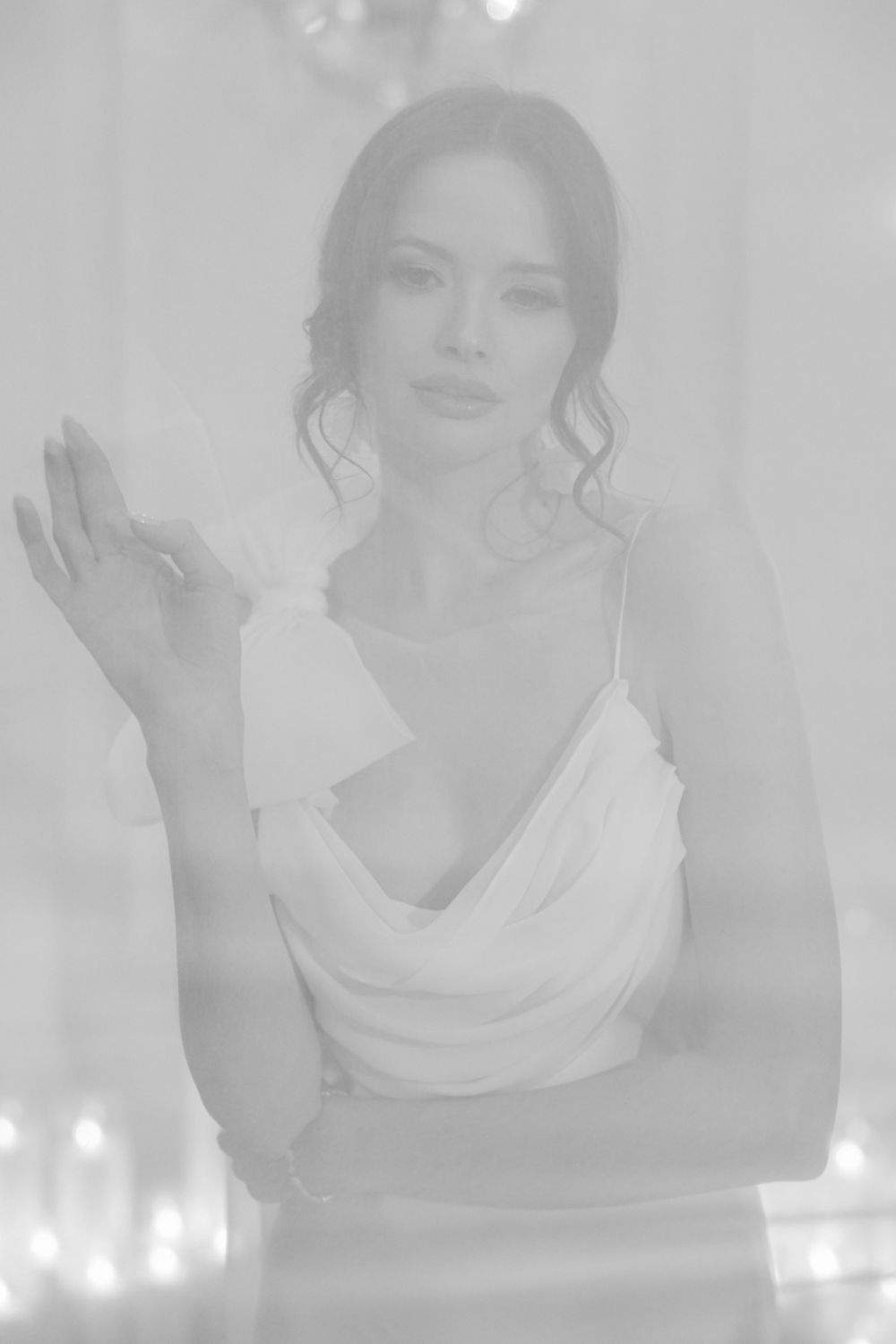 Dreamy black and white portrait shot in soft focus with ethereal lighting effects.