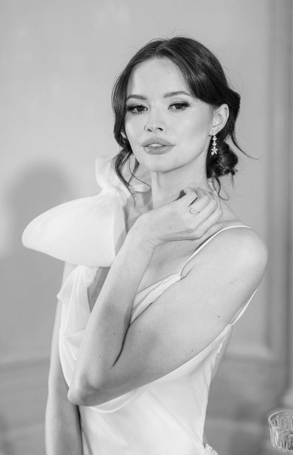 Classic bridal portrait featuring soft makeup and statement earrings.