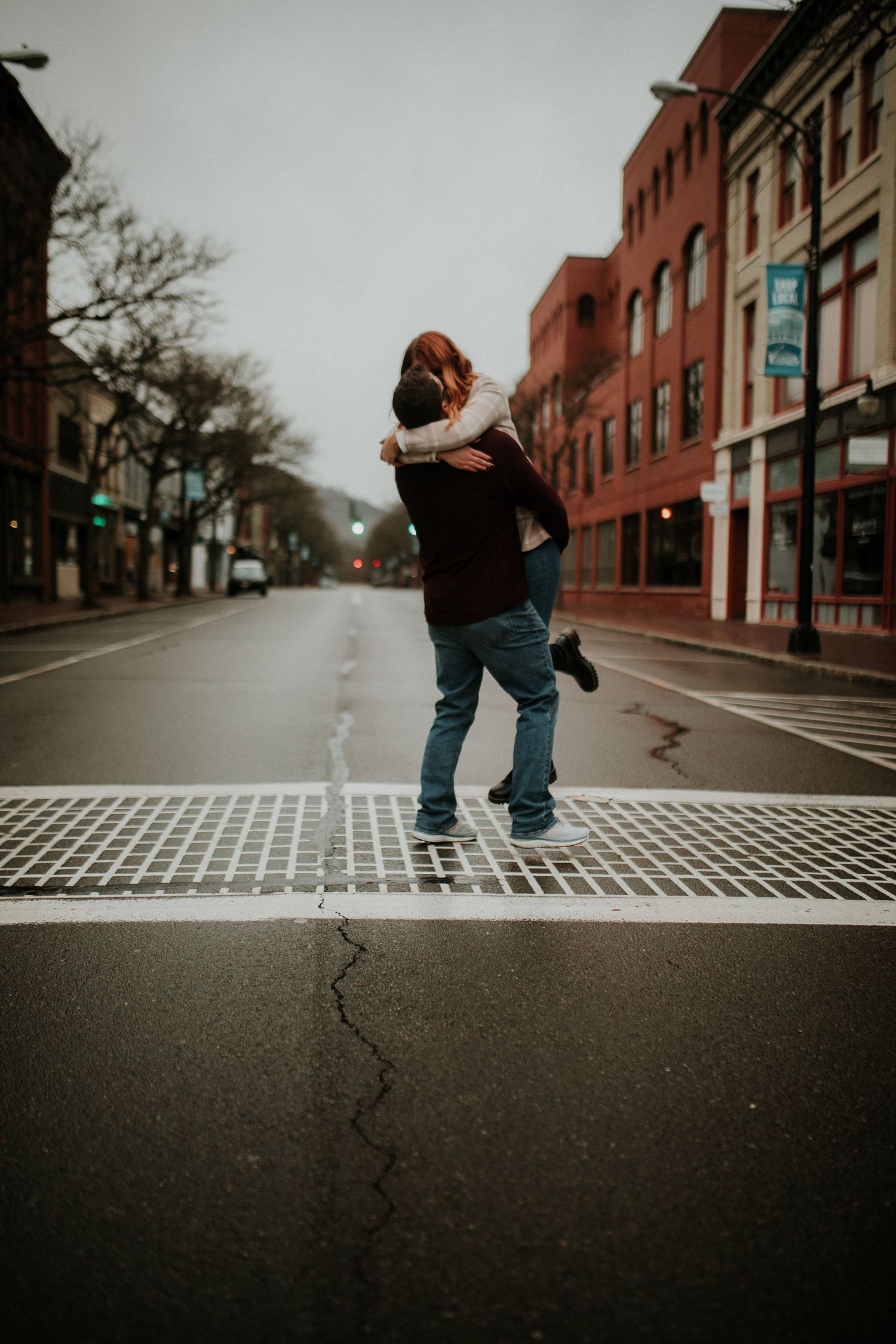 man picking up woman in the middle of the gaffer district in corning ny