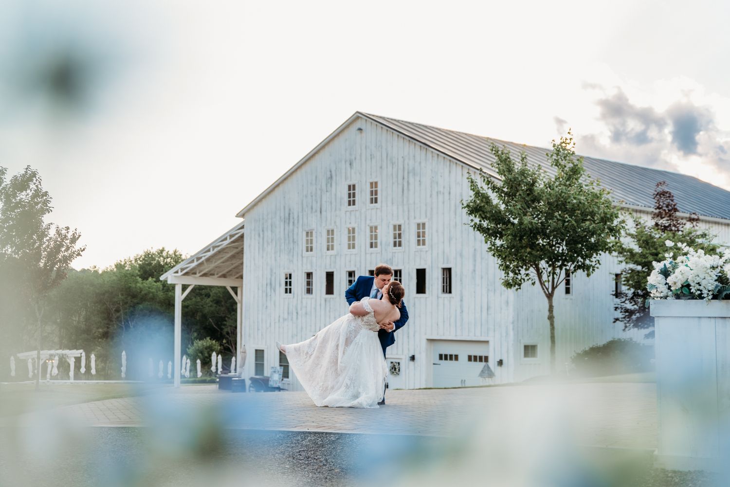Bride and groom sharing a dip kiss at The White Barn at Lucas Farms in Oakland, MD