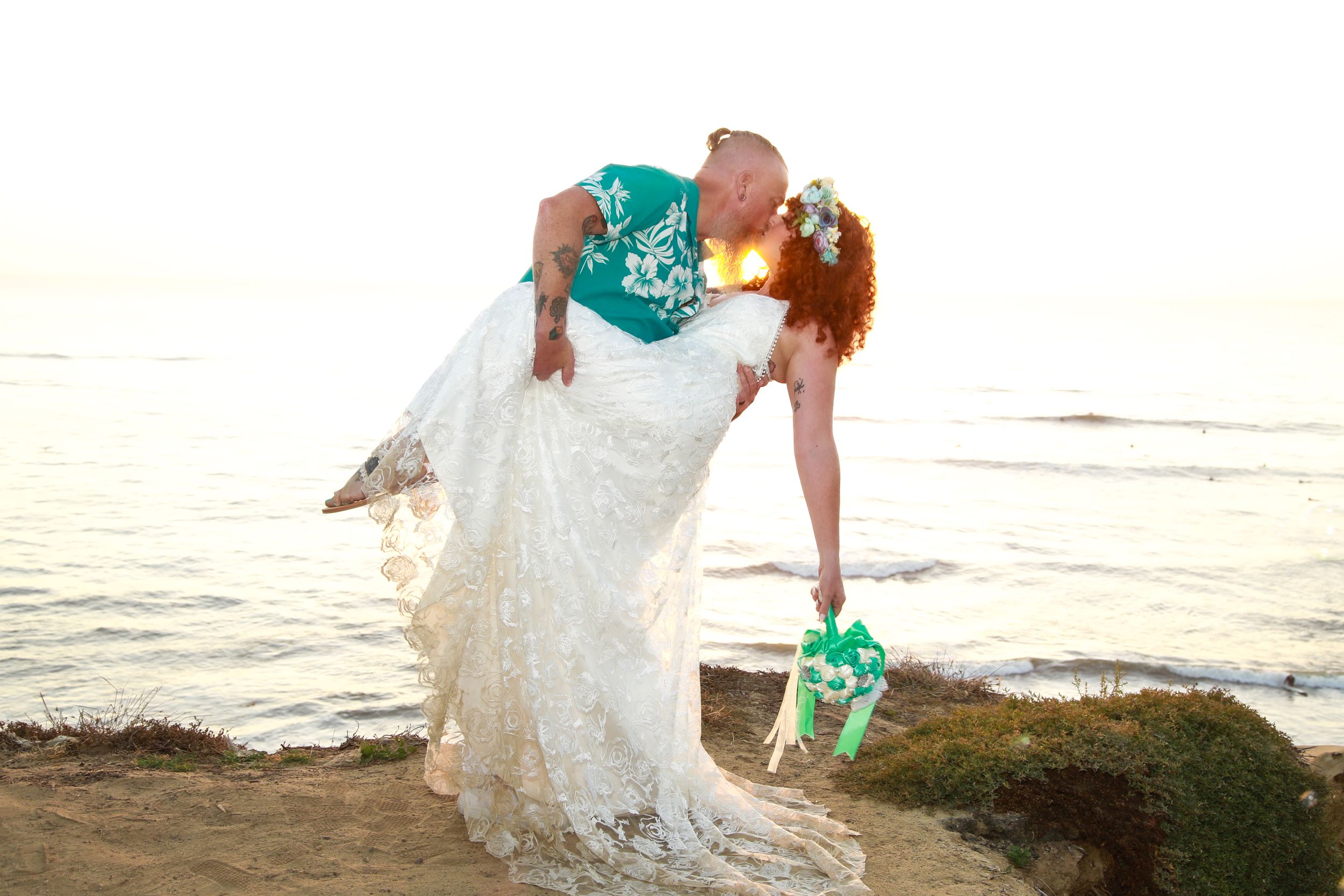 A romantic beach wedding scene with turquoise accents against the ocean backdrop.