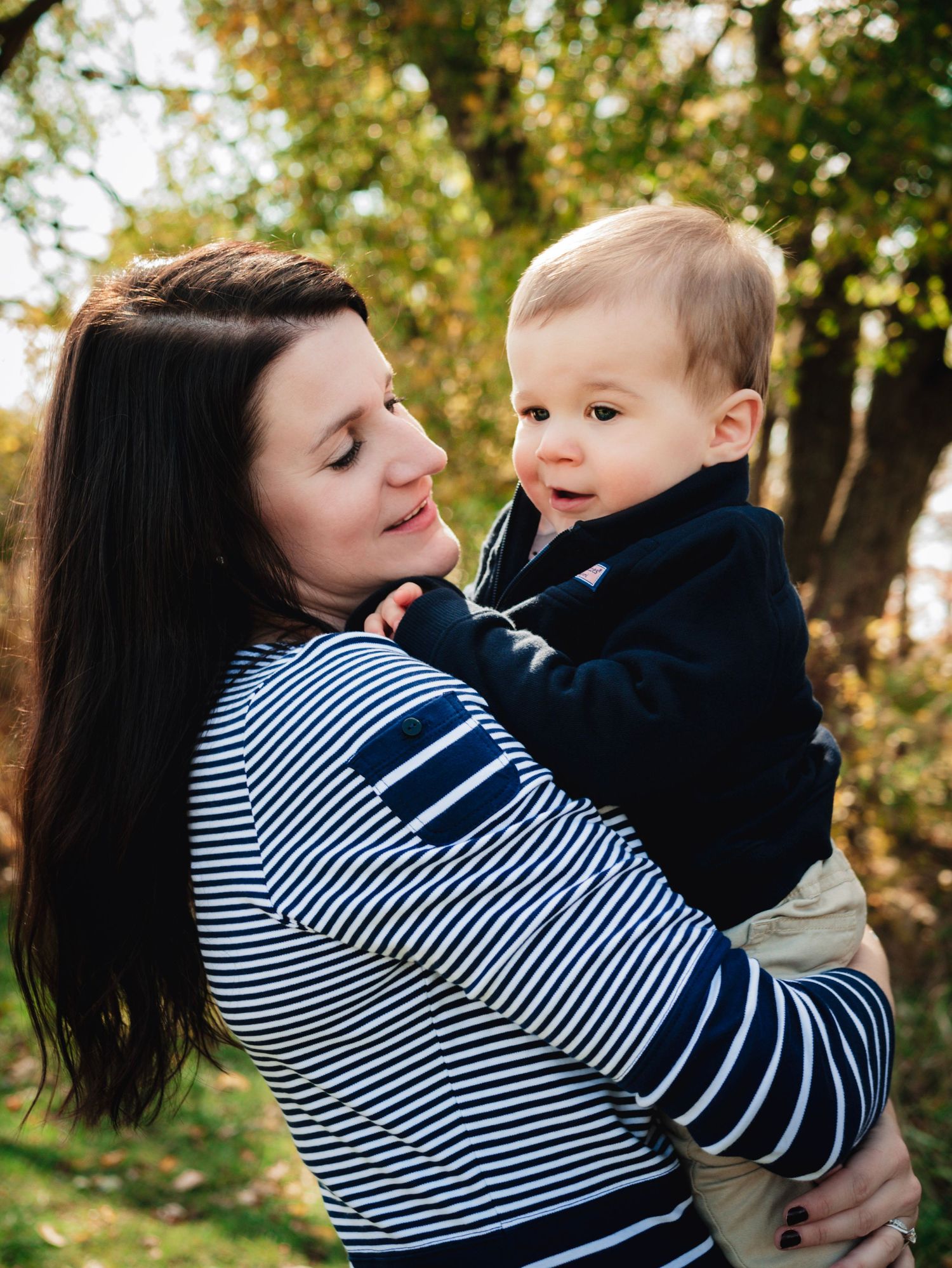 A mother holds her baby son with love in her eyes.