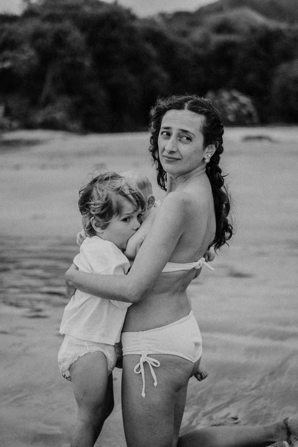 Black and white beach portrait capturing a sweet embrace.