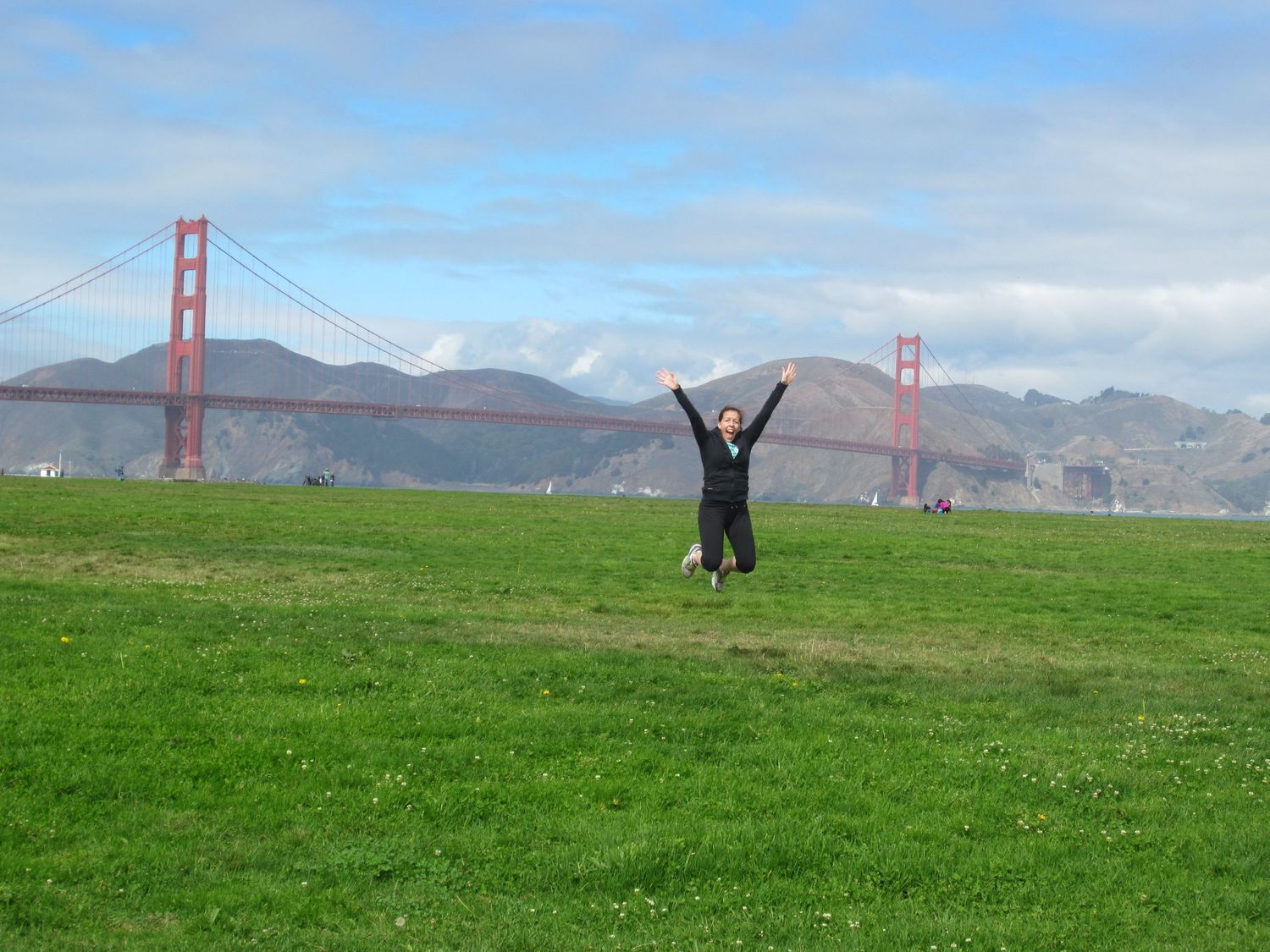 Green meadow overlooking the Golden Gate Bridge and San Francisco Bay on a clear day.