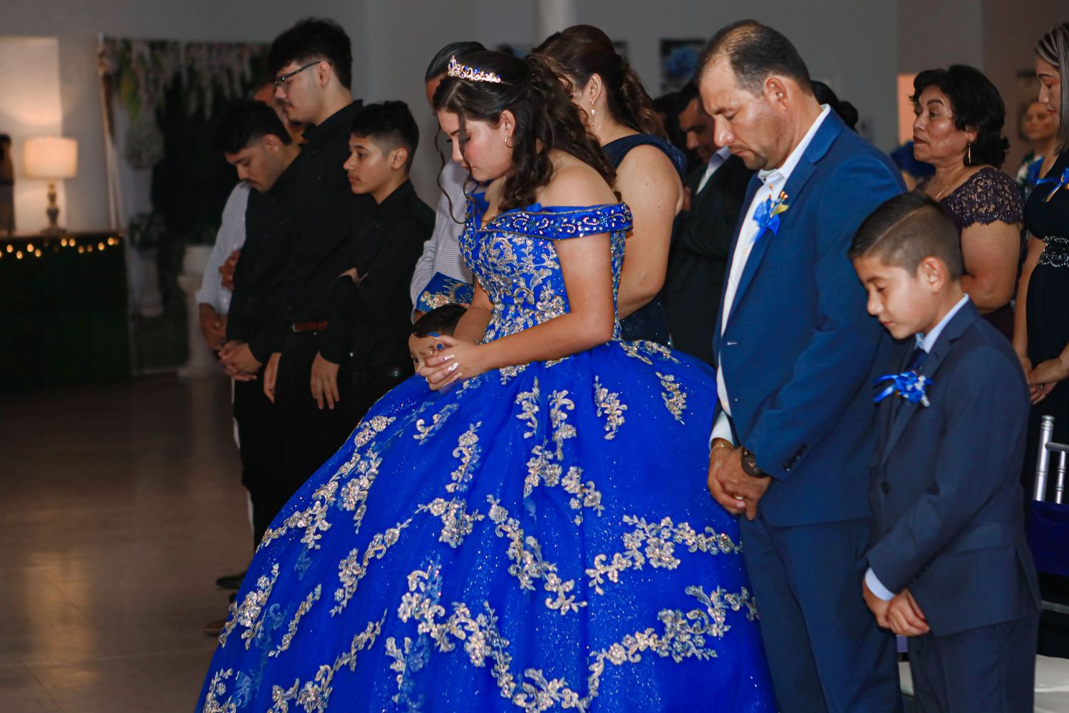 Quinceanera praying at her event