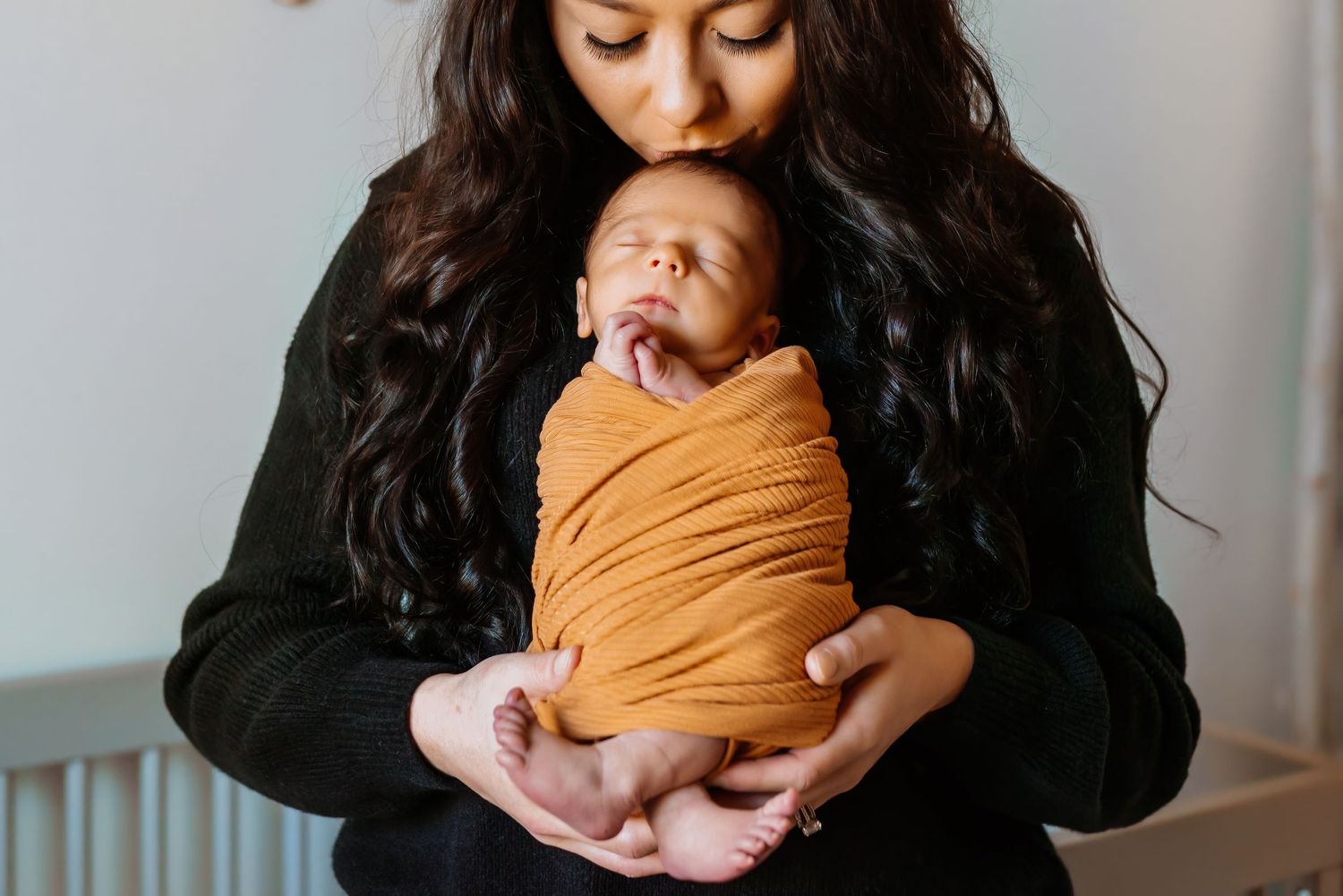 kissing newborn babys head