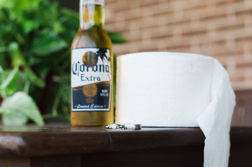 Corona Extra beer bottle next to a white napkin on wooden surface.