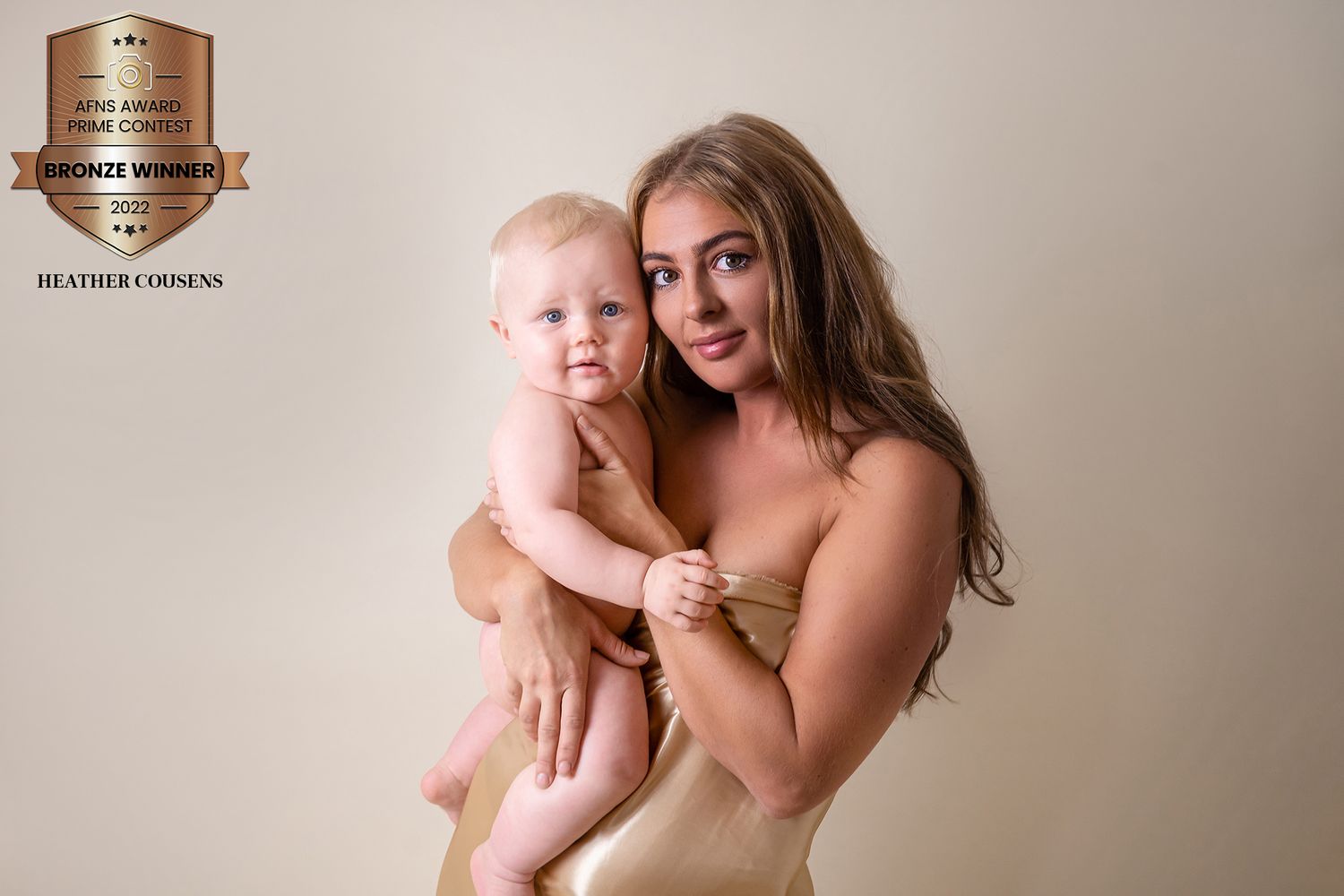 Mum with long blonde hair with toddler boy on cream background by newborn photographer in Doncaster