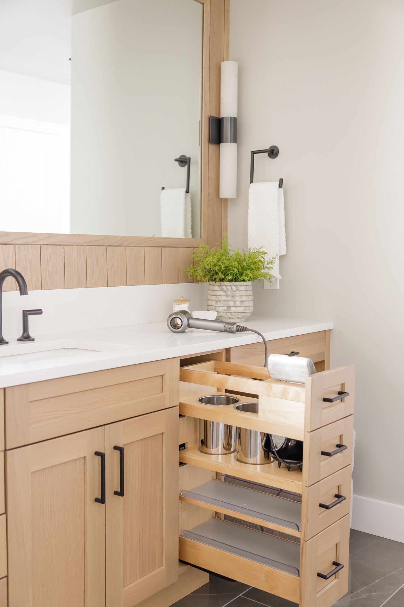 H. Bero Interior Design photos master bathroom hidden pull out draw system with hair dryer on vanity in Bellevue, WA