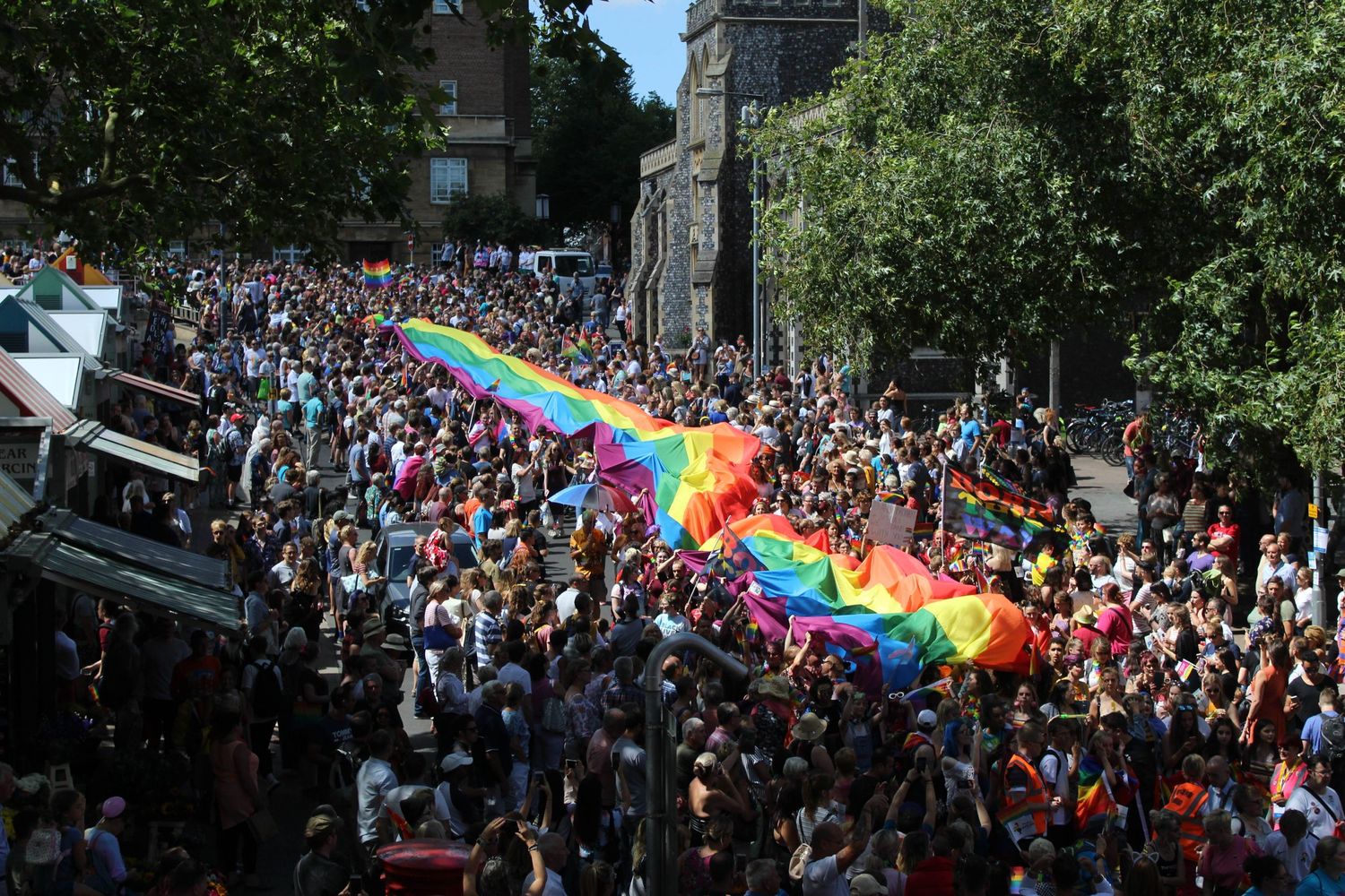 An expressive photo of a LGBT rainbow flag during a pride parade in Norwich.