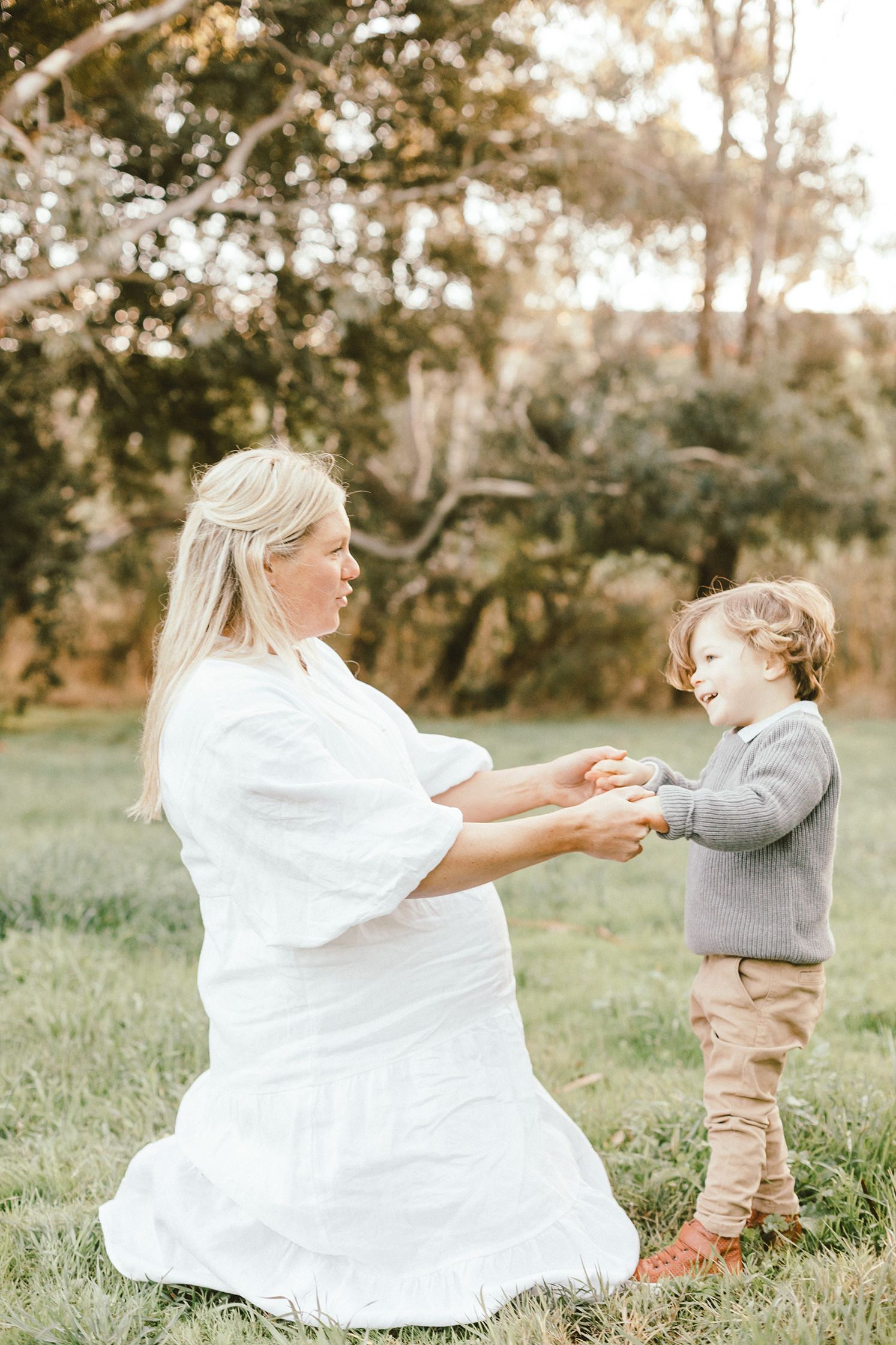 Touching moment between parent and child playing together in an outdoor setting.