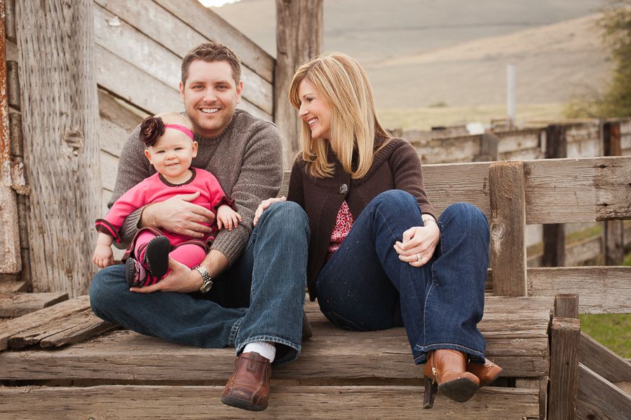 Casual family photos taken on wooden benches by water.