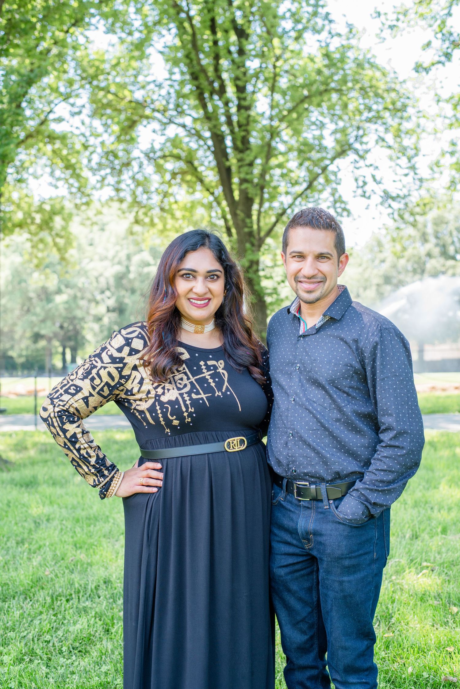 husband and wife pose together, looking at camera
