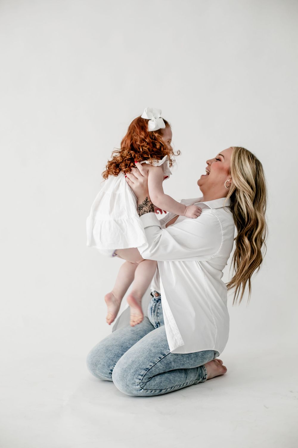 A playful series of photos showing joyful interaction between parent and child in white outfits against light background.