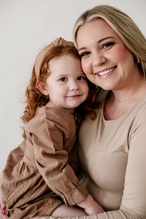 Heartwarming portrait series showing tender moments between parent and child in neutral tones.