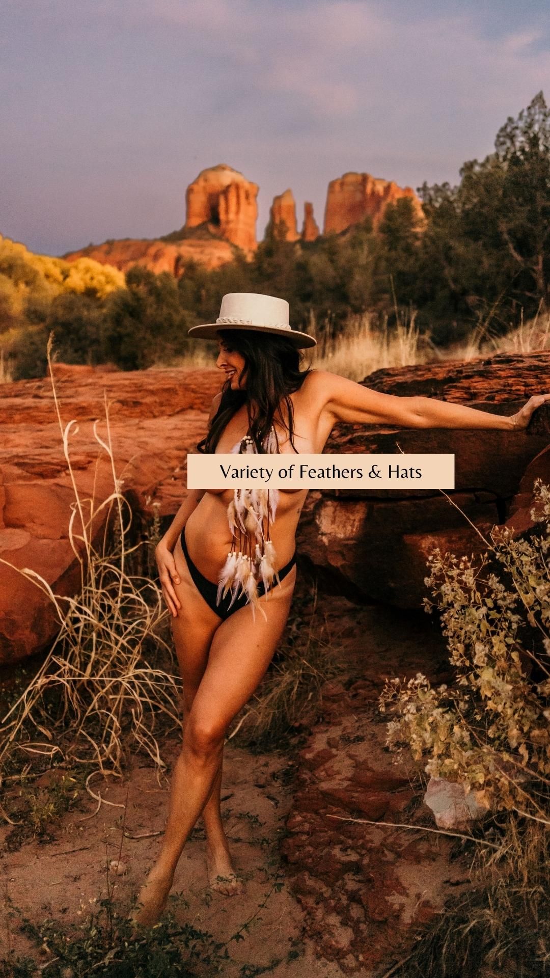 White hat and feather accessories showcased against majestic desert rock formations.
