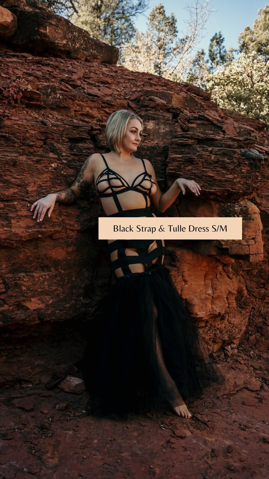 Black strappy tulle dress photographed against red rock formations at sunset.