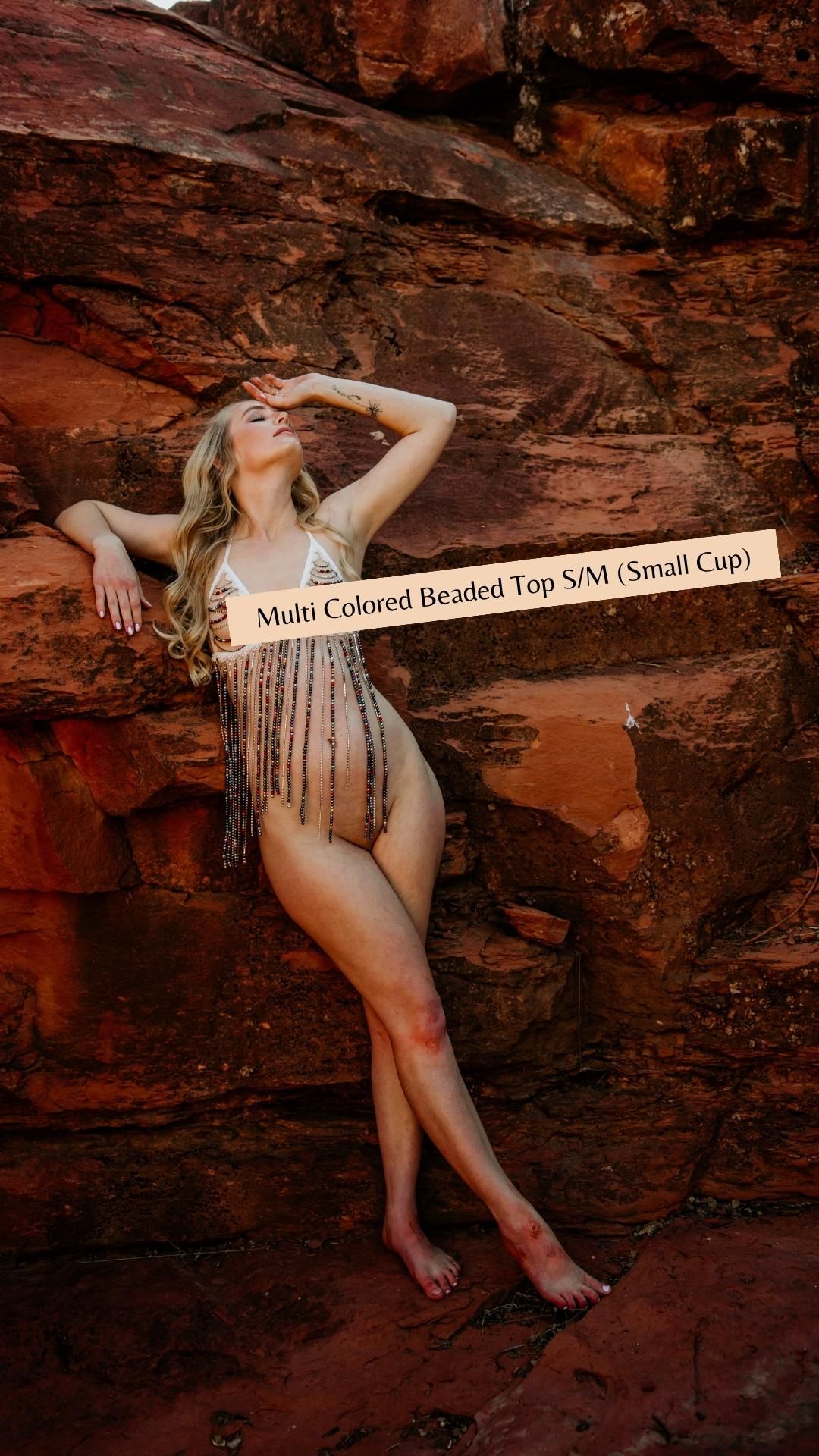 Fashion product photography featuring beaded top against dramatic red rock desert backdrop.