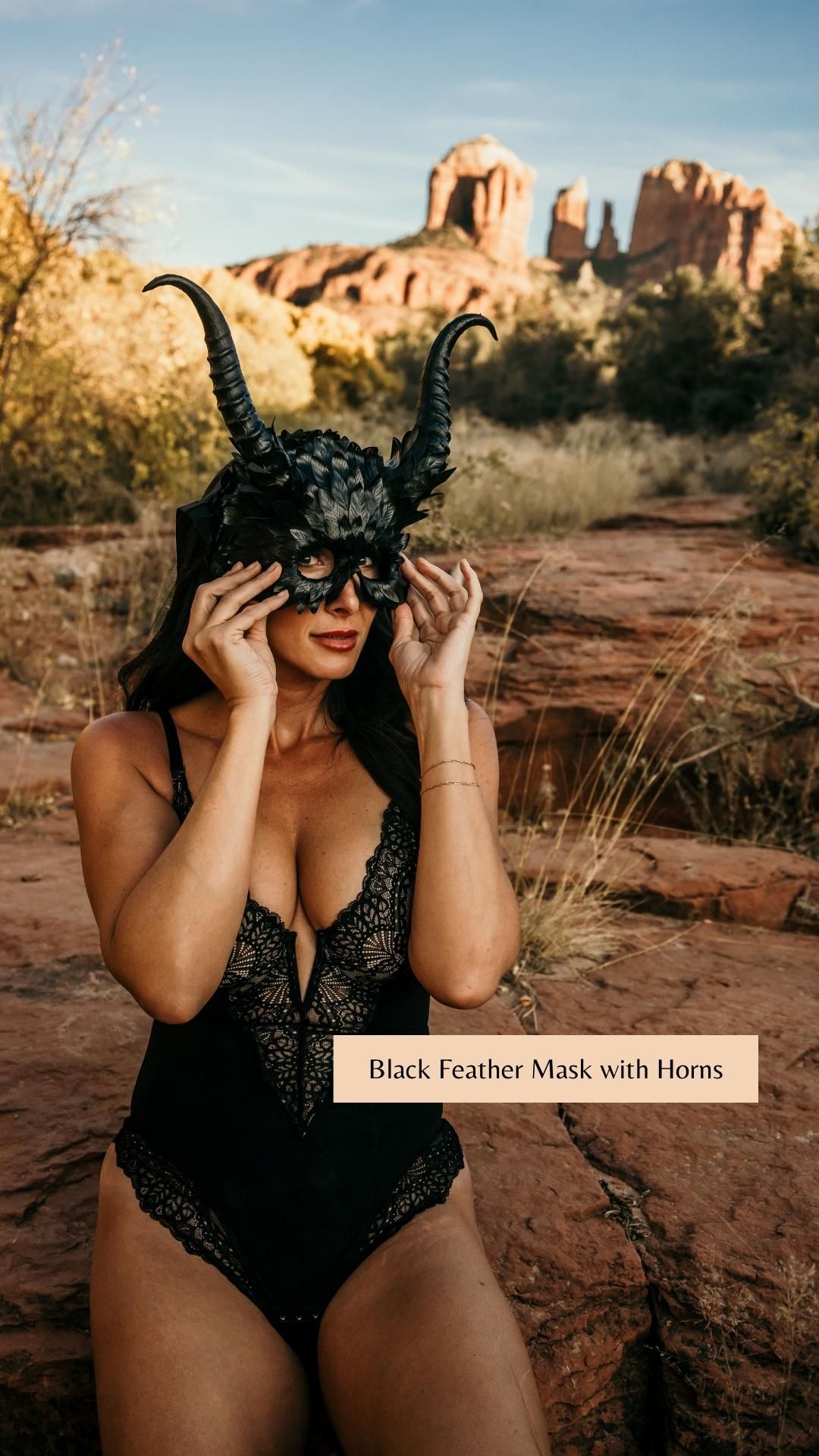 Dramatic horned feather mask worn with black bodysuit against red rock formations in Sedona.