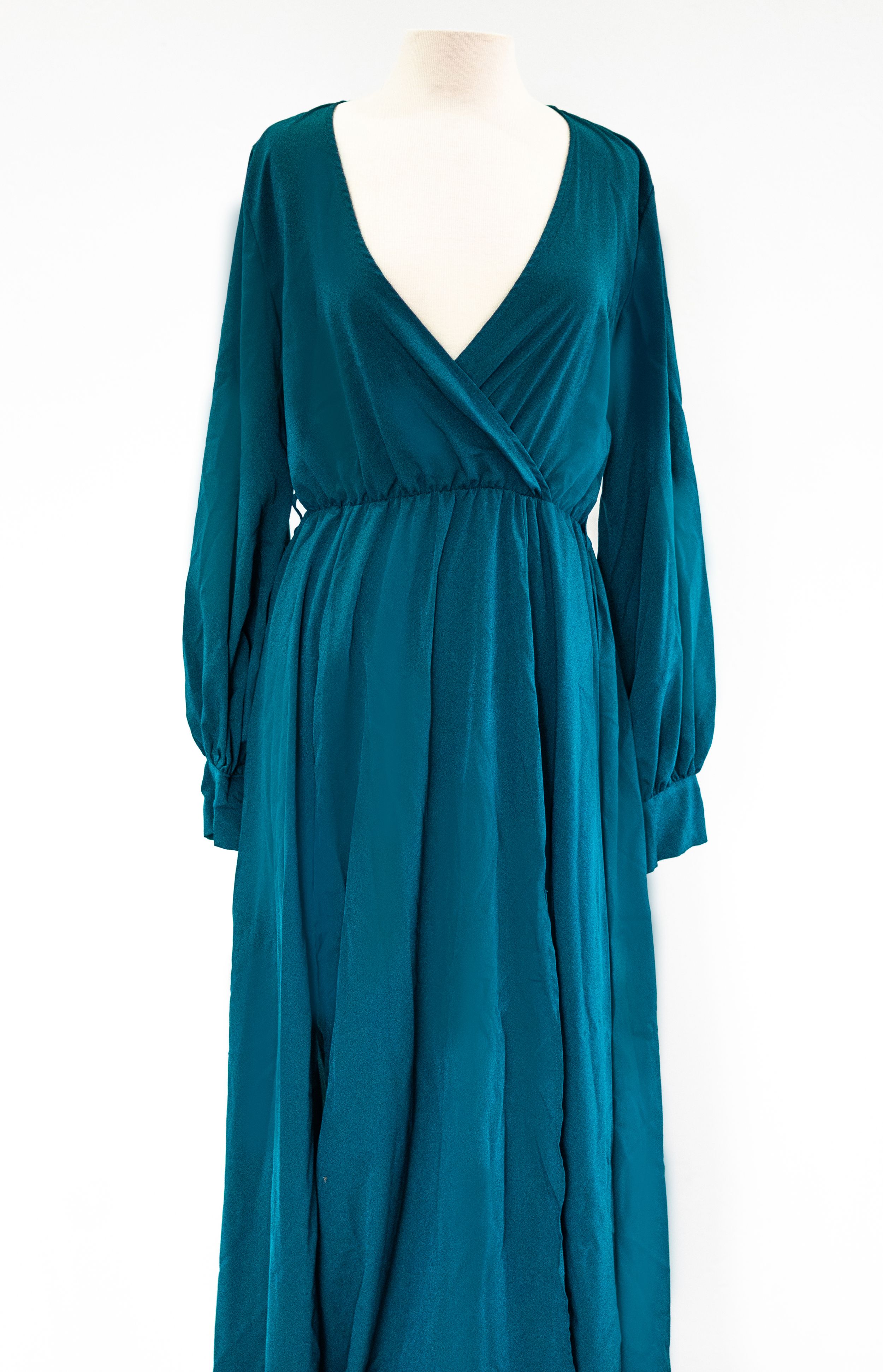 Elegant teal maxi dress with wrap front and long bishop sleeves displayed on mannequin.