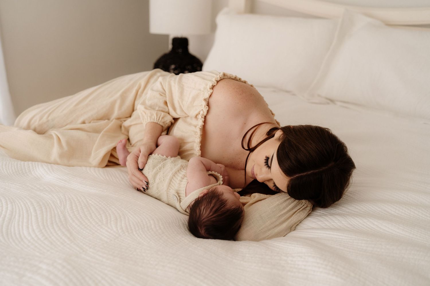newborn session woman on bed with baby Auckland