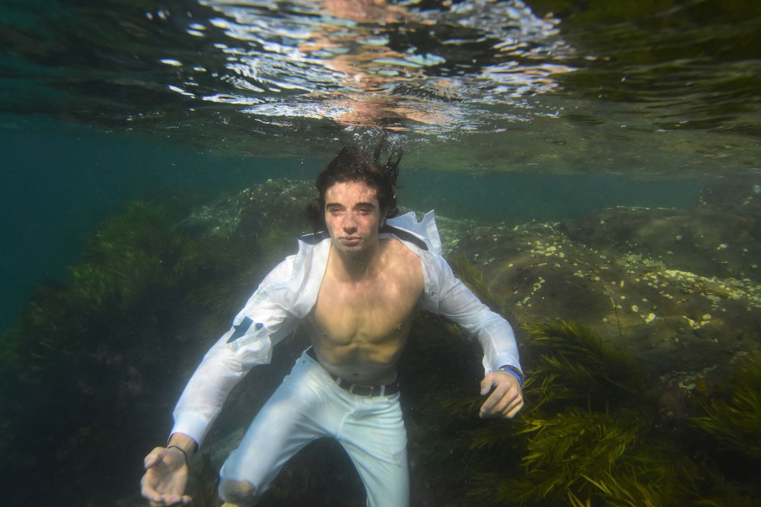 Authentic, storytelling editorial family underwater photography capturing real moments with depth, emotion, and a strong visual narrative