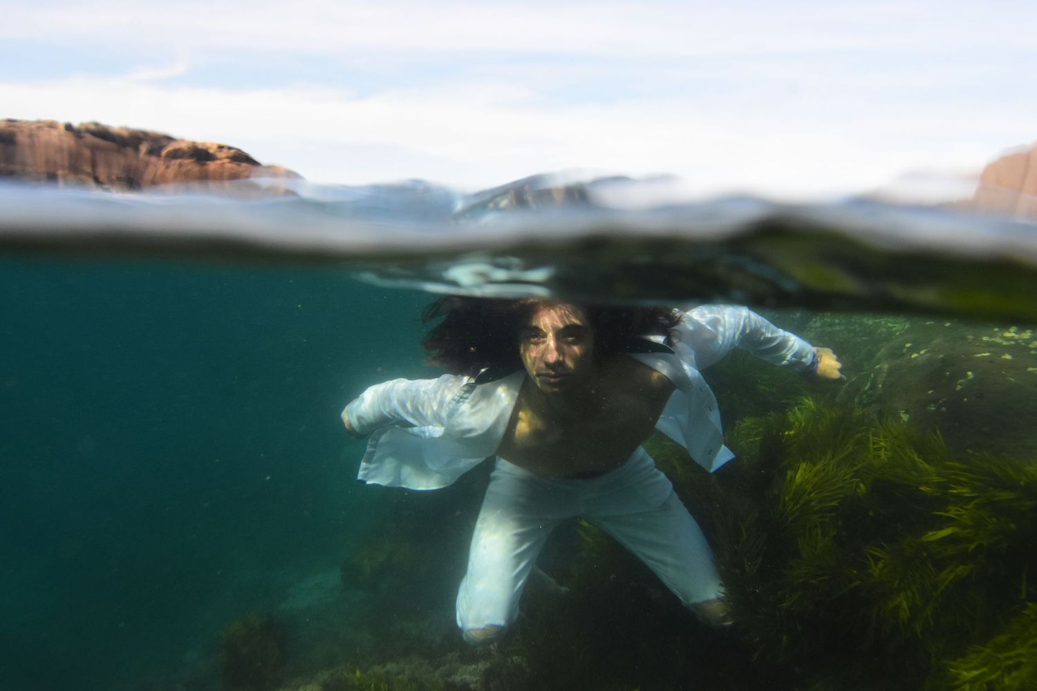 Authentic, storytelling editorial family underwater photography capturing real moments with depth, emotion, and a strong visual narrative