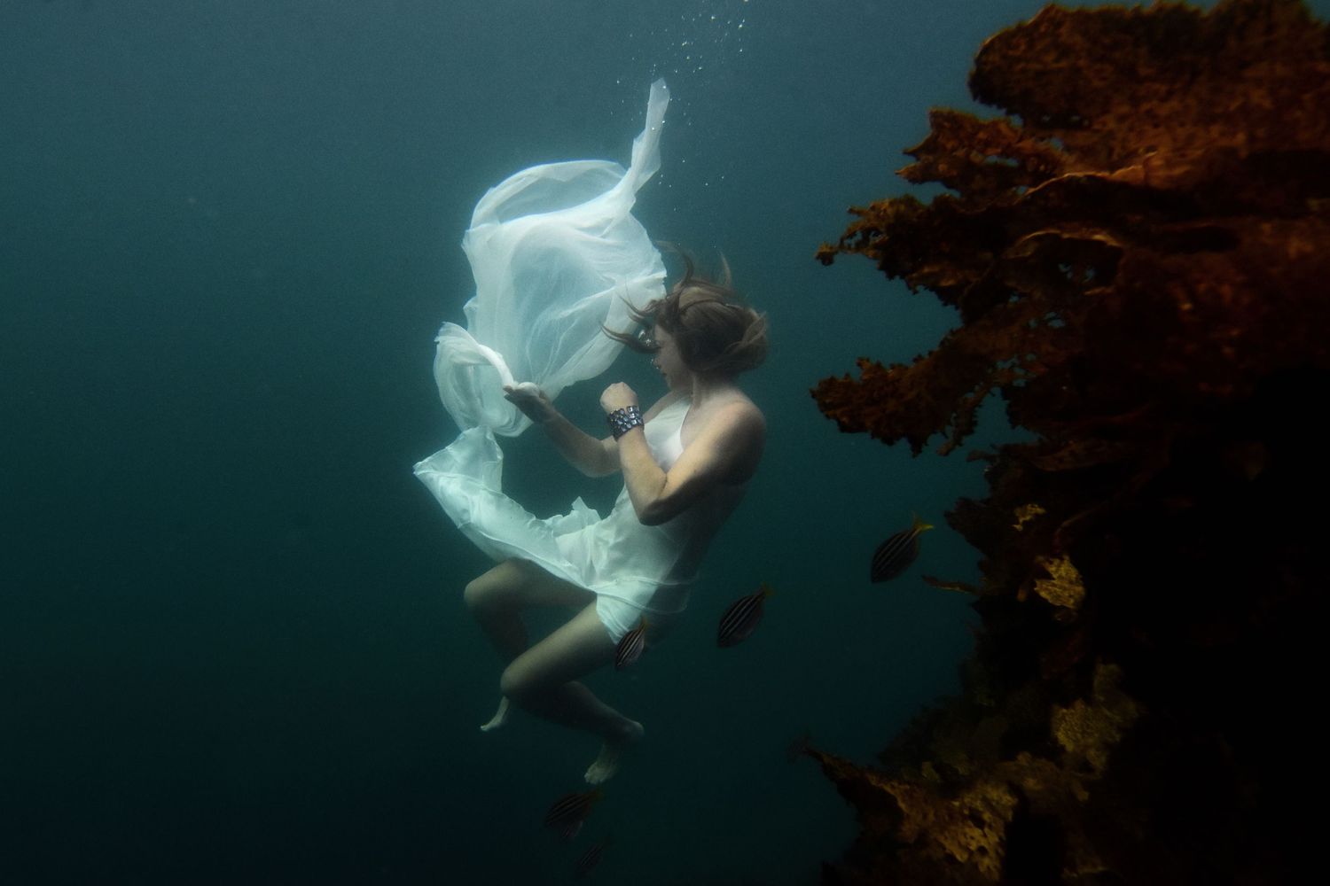 Authentic, storytelling editorial portrait underwater photography capturing real moments with depth, emotion, and a strong visual narrative