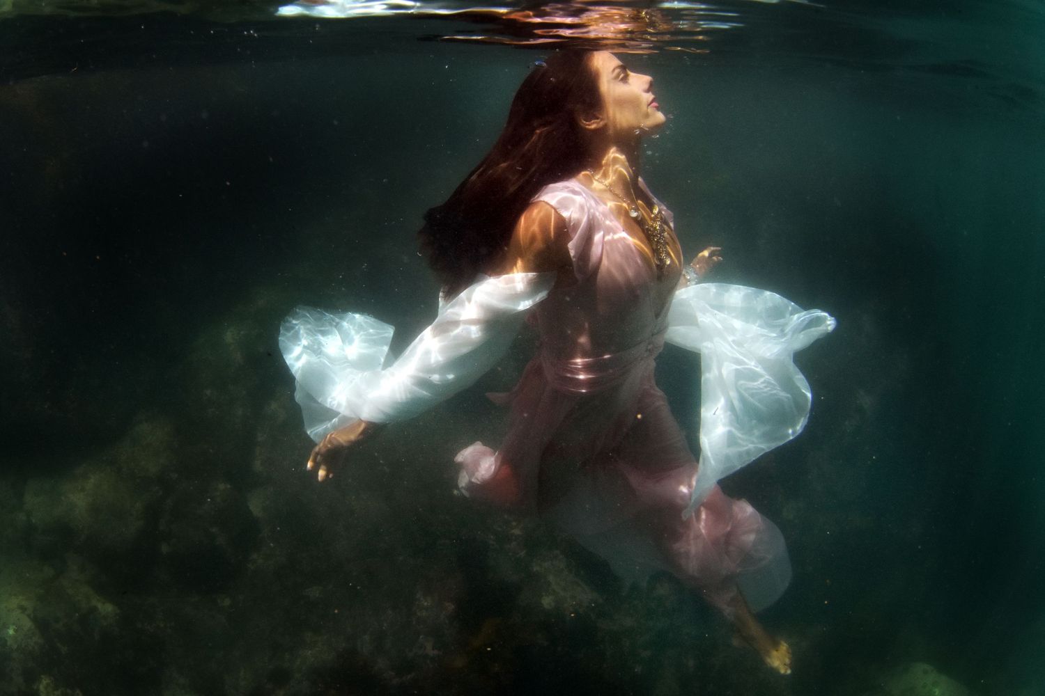 Authentic, storytelling editorial portrait underwater photography capturing real moments with depth, emotion, and a strong visual narrative