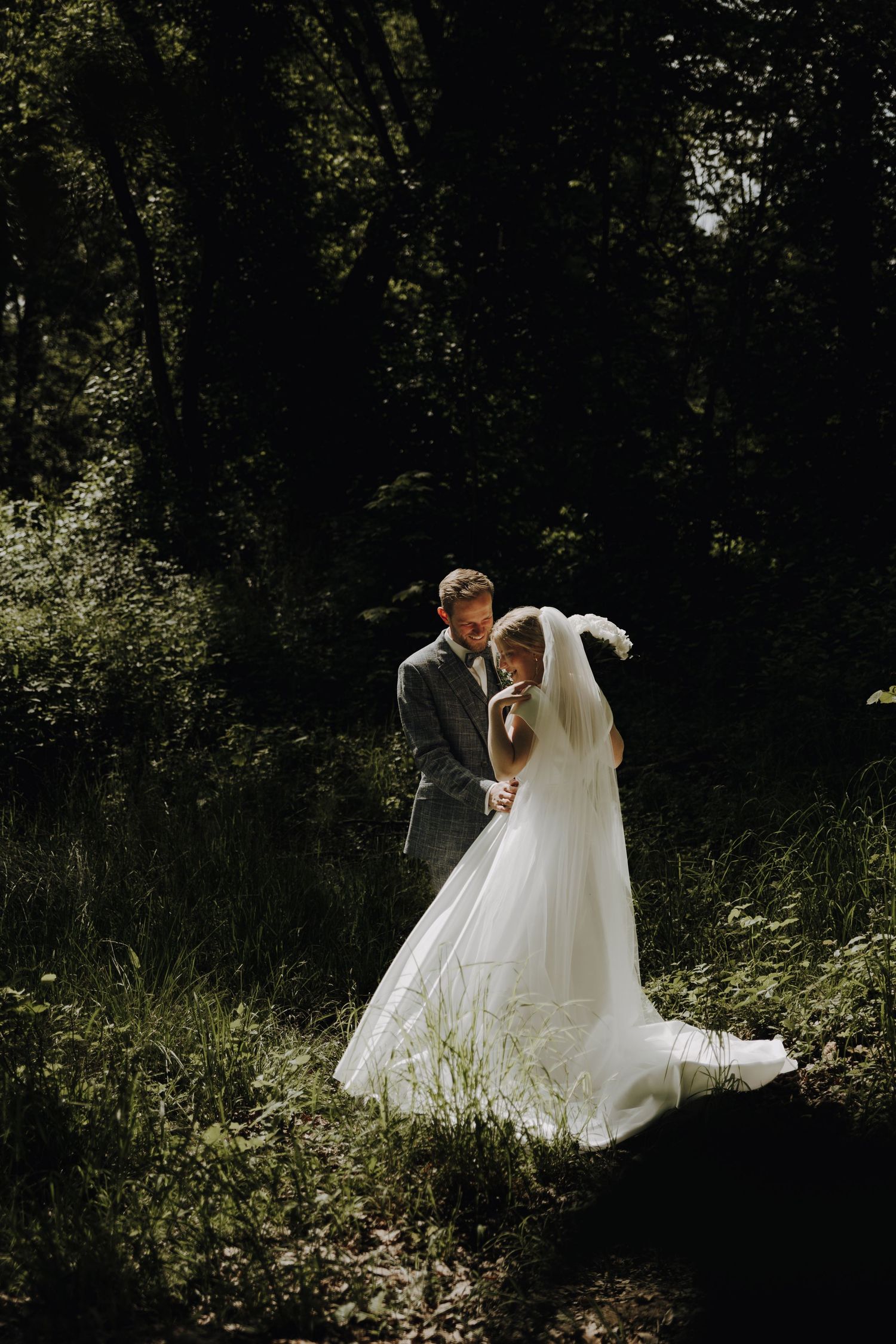 Sunlit outdoor scene with flowing white wedding dress moving through nature.