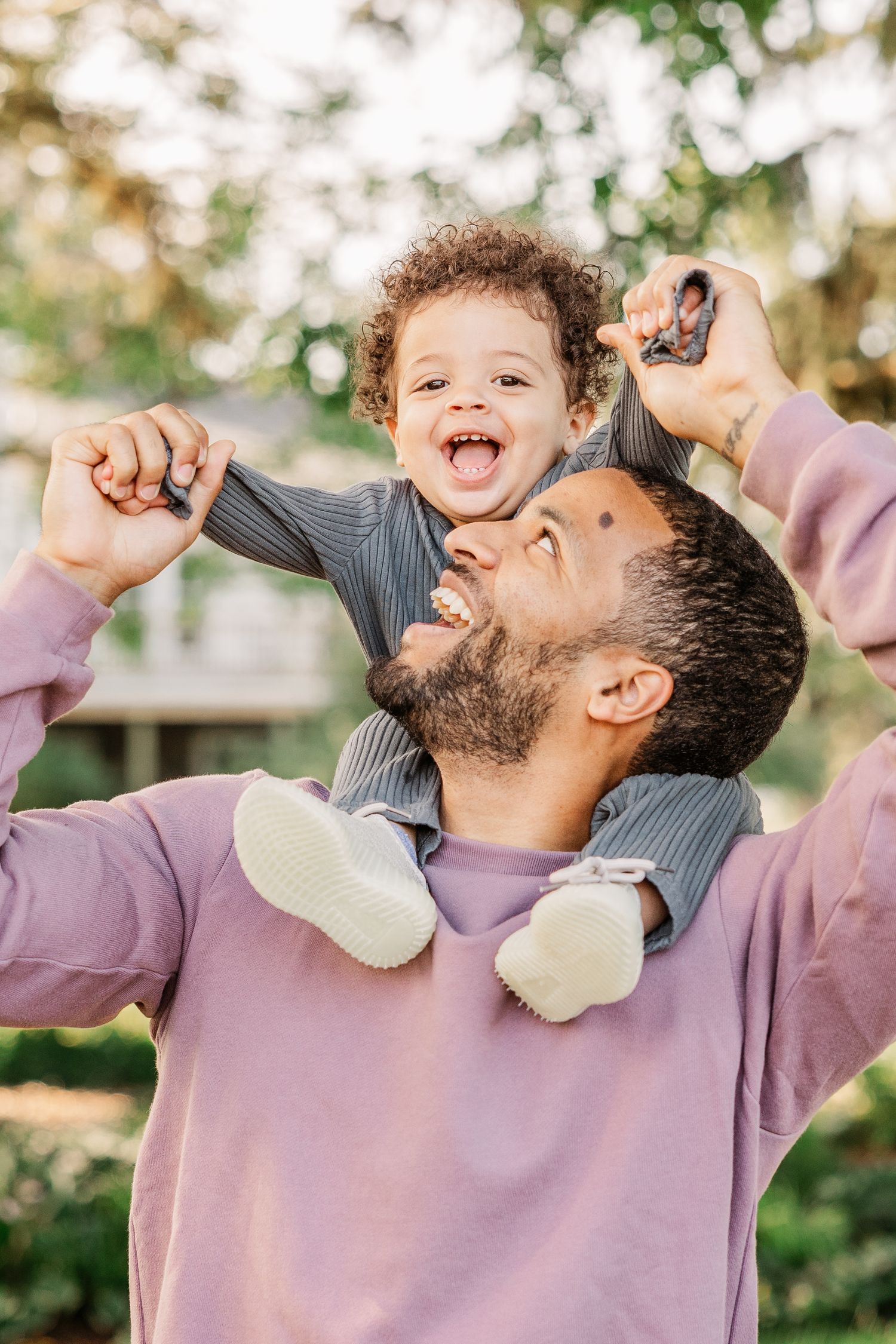 Joyful playtime moment captured between parent and child outdoors.
