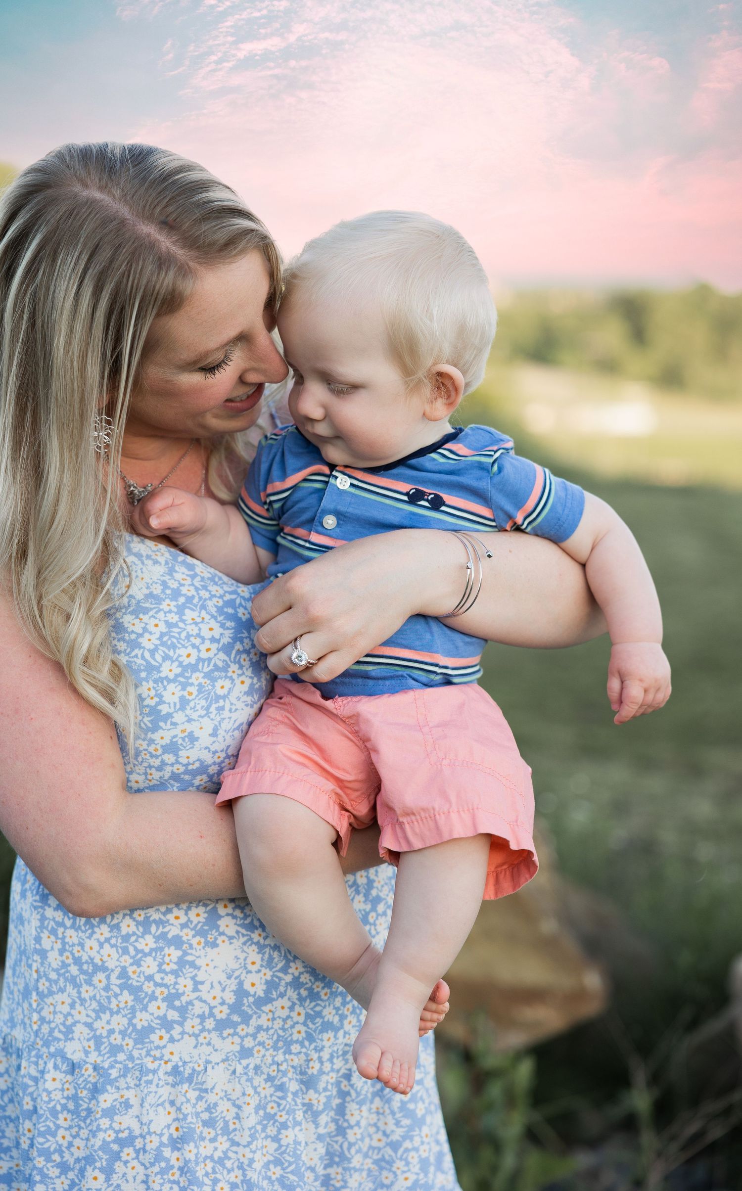 Mom holding son snuggling face cute mommy and me pose