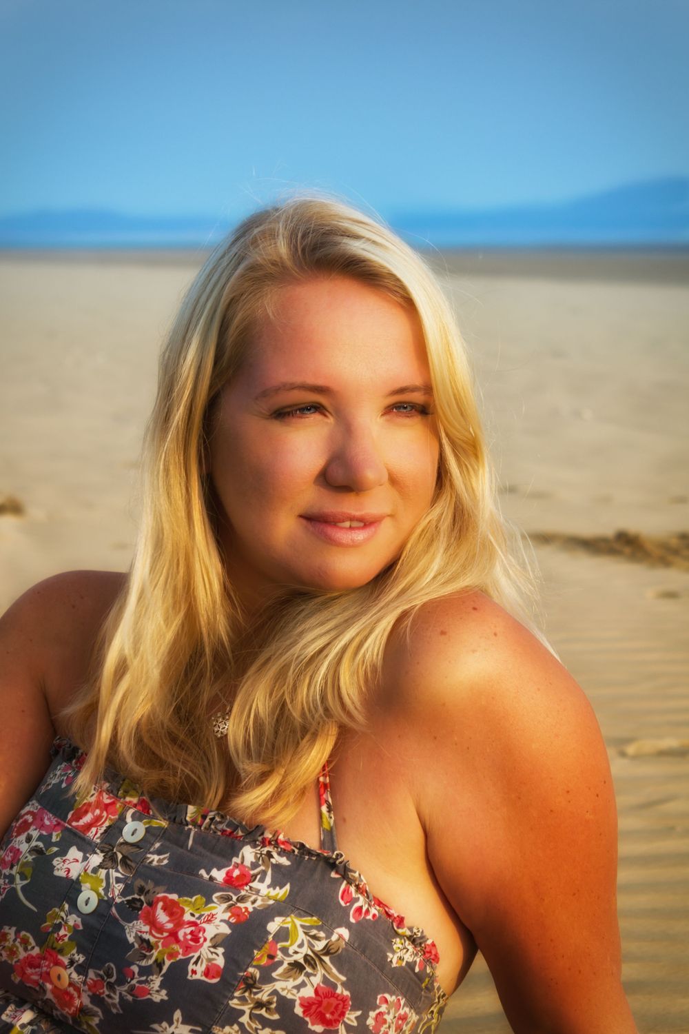 A sequence of beach portraits featuring floral clothing against sand and blue sky.