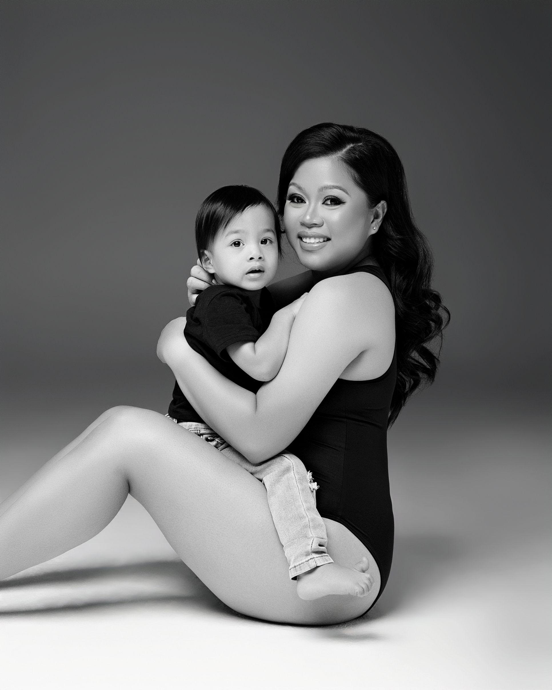San Diego studio Mommy and Me photoshoot with an asian model wearing a black bodysuit, captured by Daryana Orange.