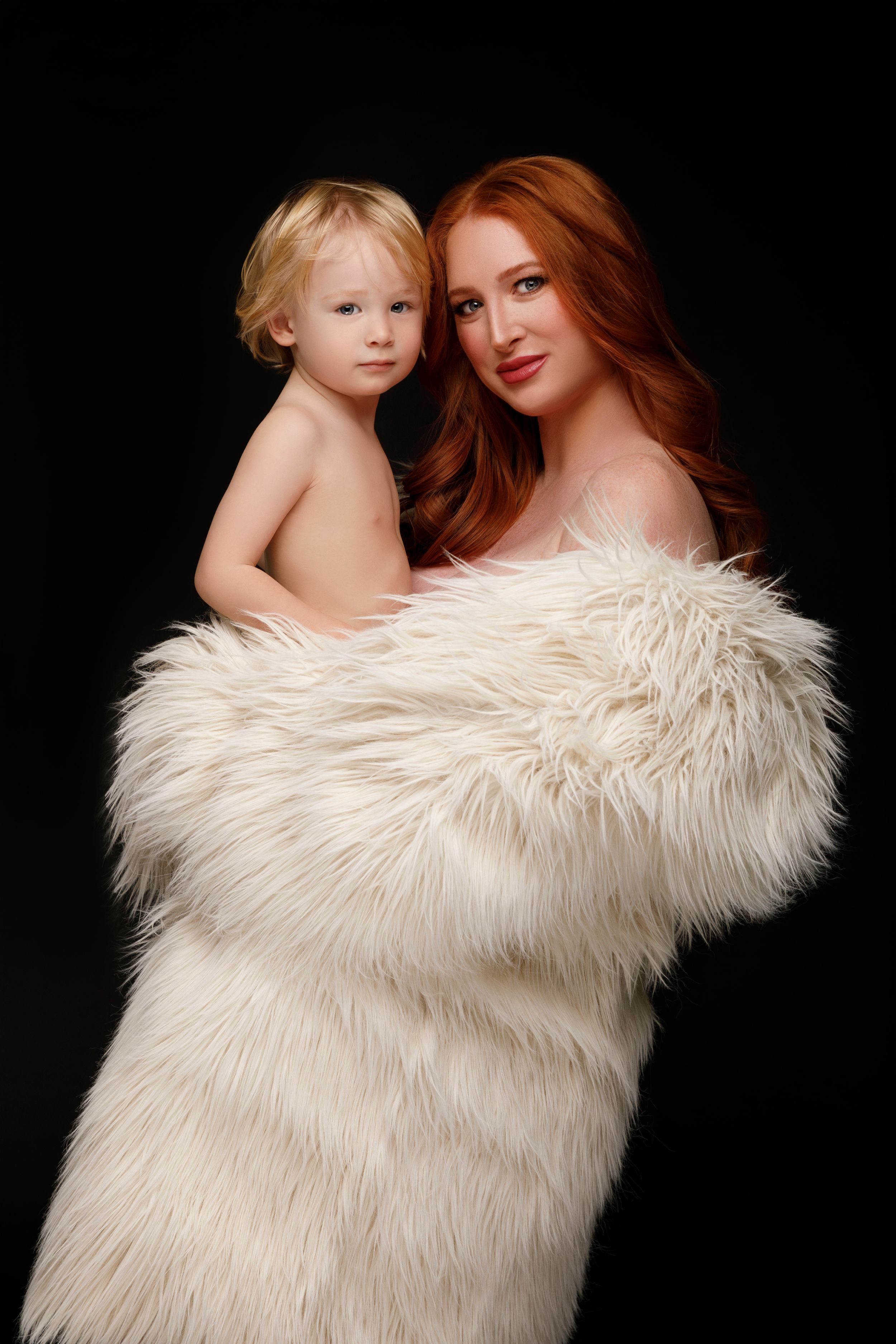 San Diego studio Mommy and Me session, a redhead model wearing a white faux fur coat, captured by Daryana Orange.