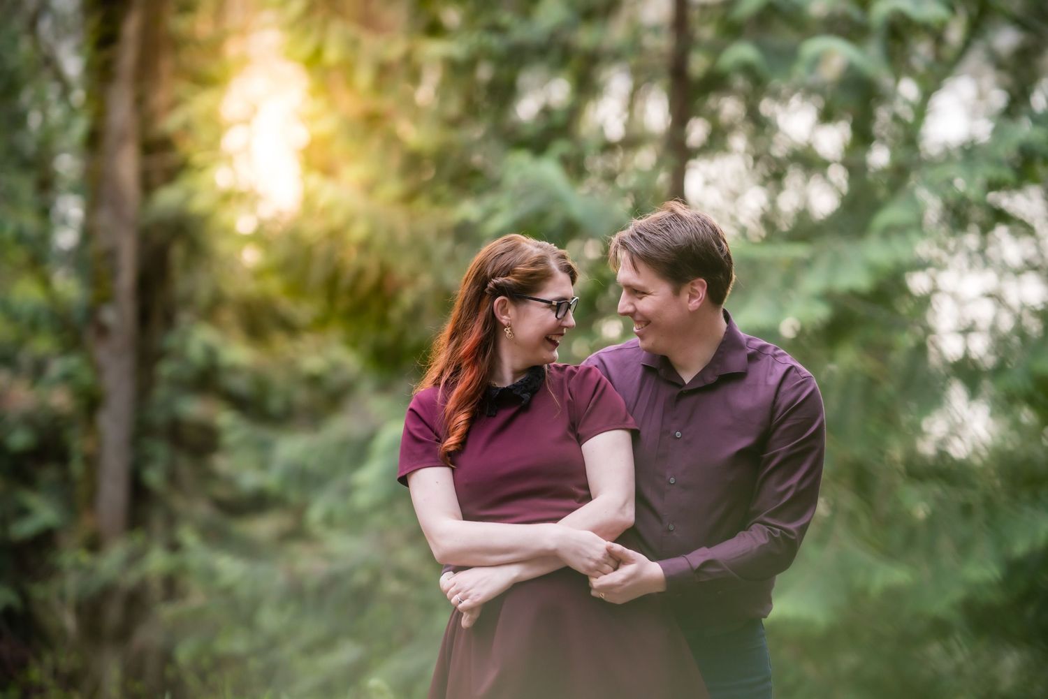 Romantic outdoor photoshoot in a wooded area during golden hour.
