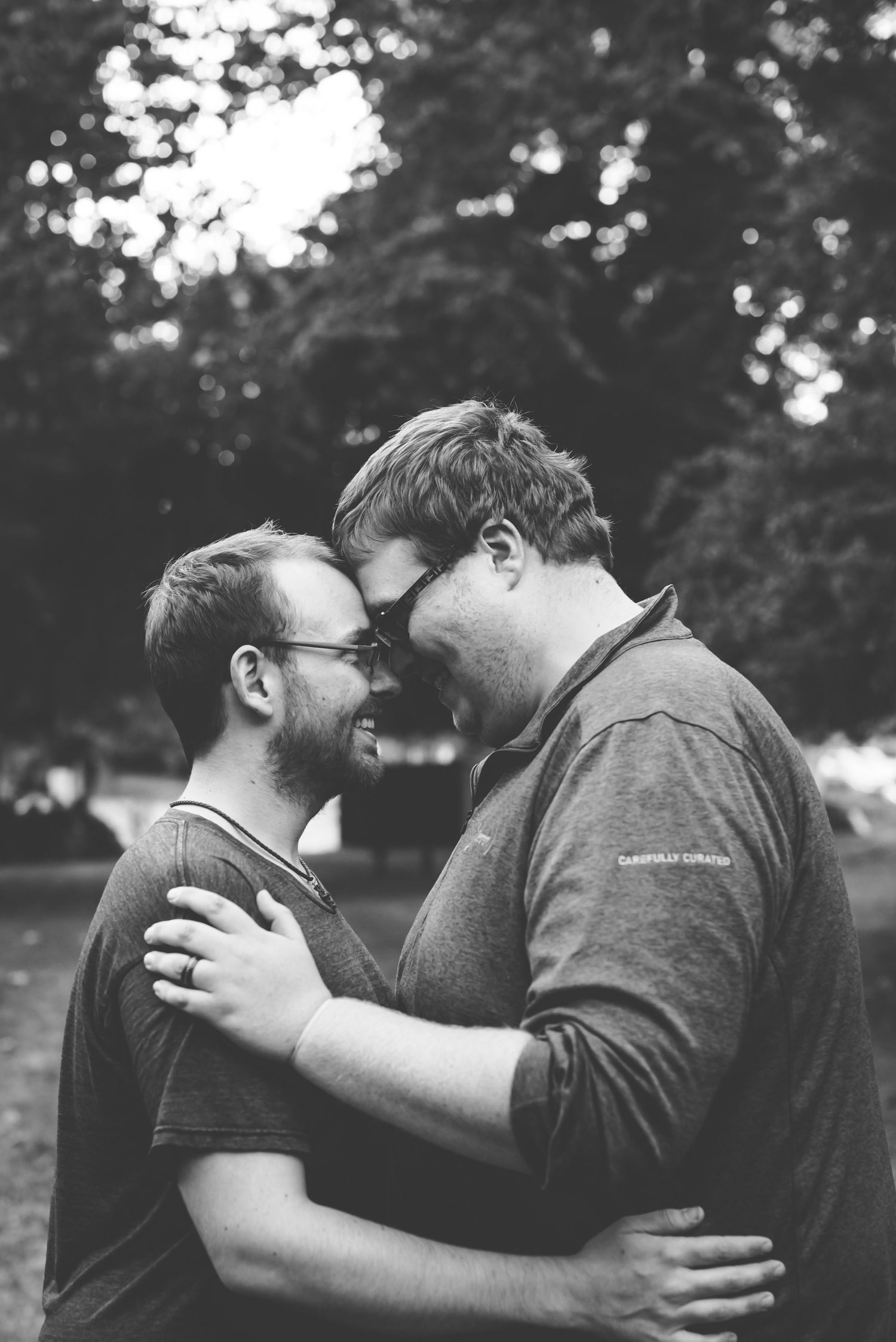 Black and white photo series showing two people embracing in an emotional moment outdoors.