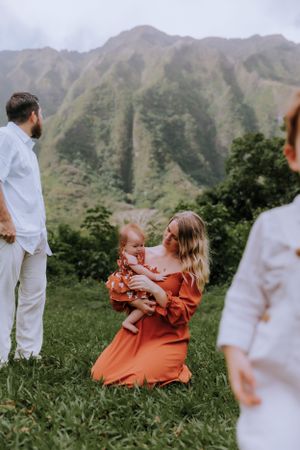 A serene family moment captured against the backdrop of majestic mountain peaks.