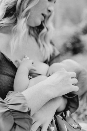 Intimate black and white close-up of tender family moment outdoors.