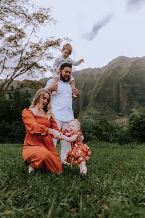 A happy family sharing laughter and joy against a backdrop of stunning mountain peaks.