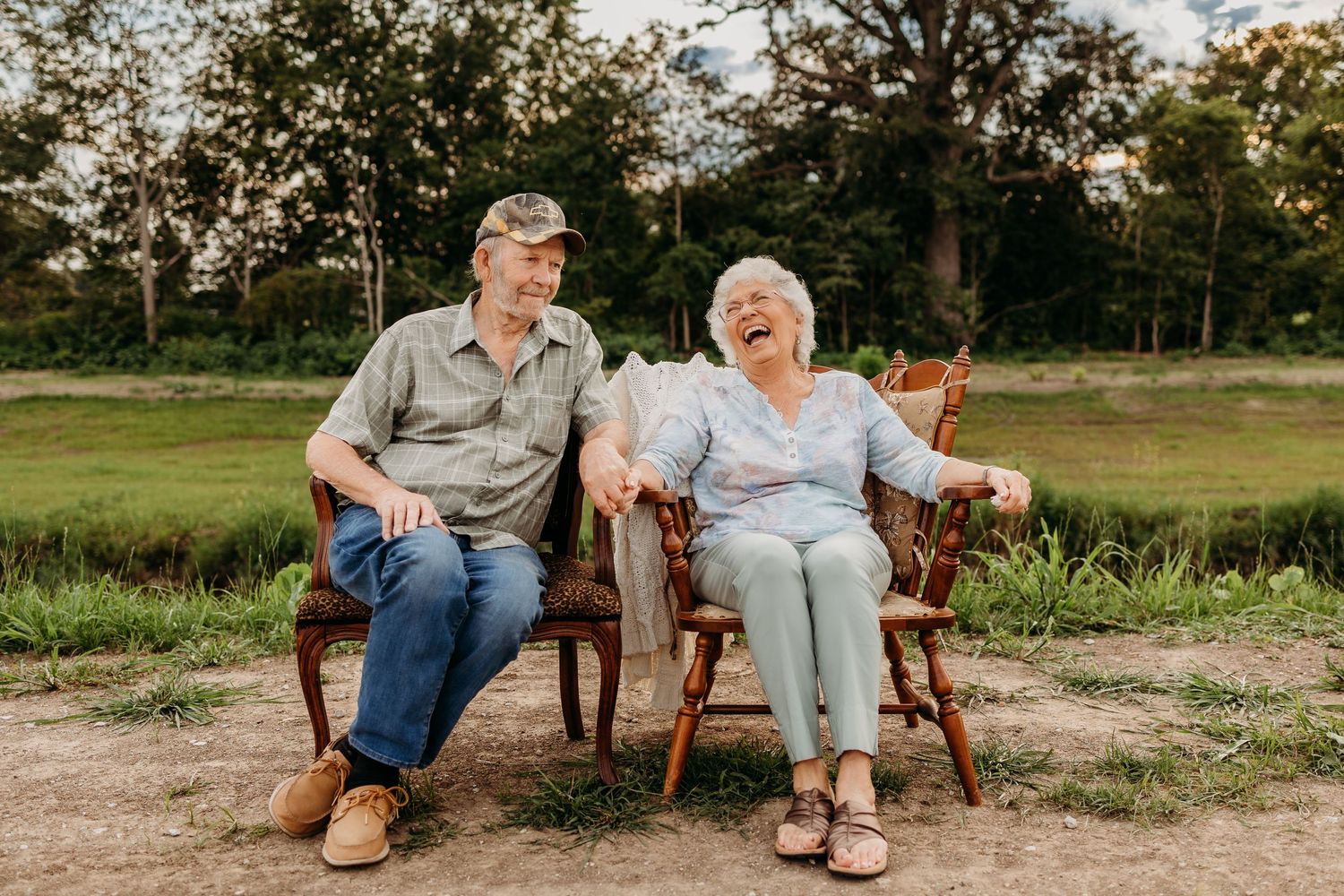 Elderly couple sitting together by the creek in Tipton park