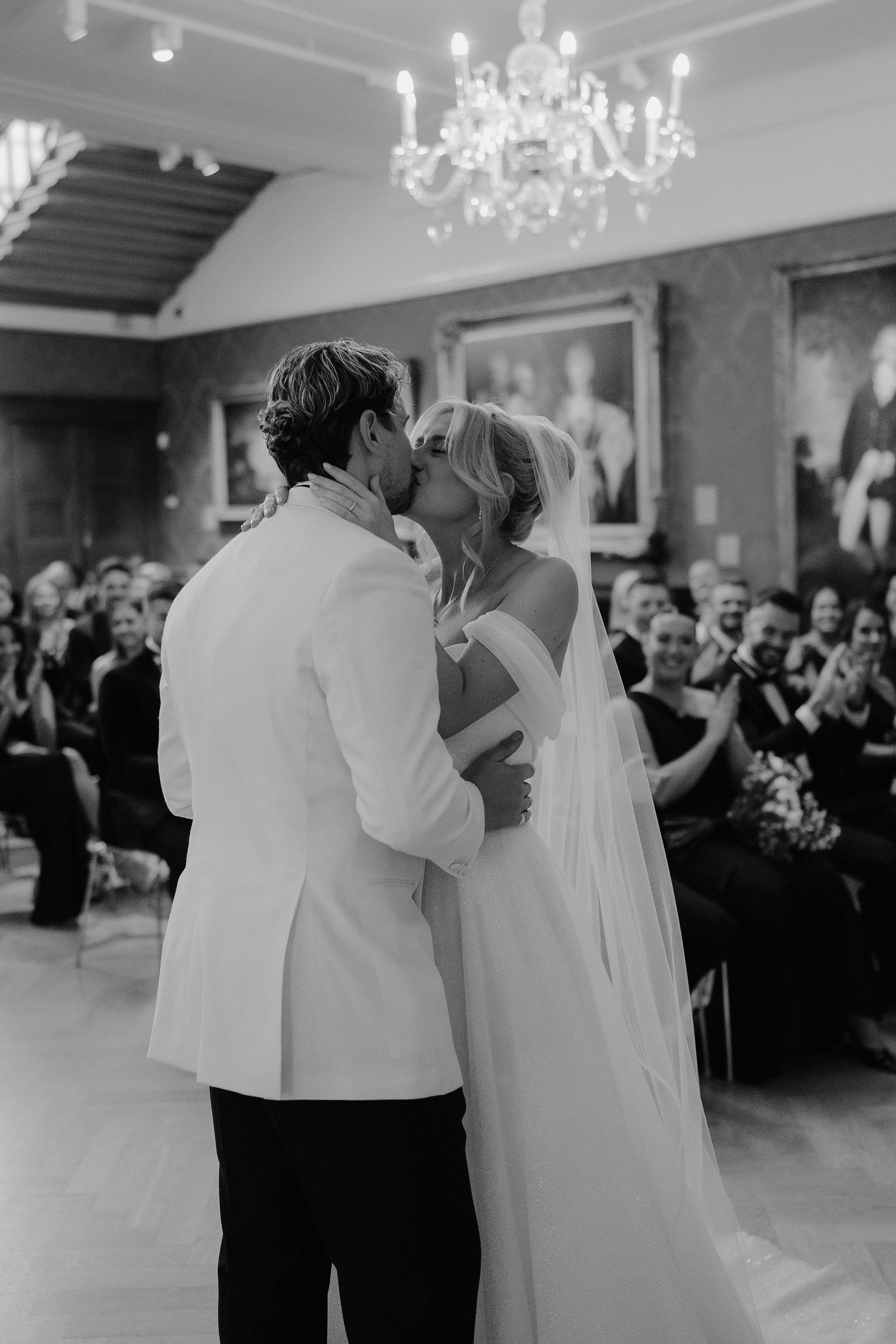 bride and groom sharing first kiss at the alter in the European art gallery at the ashmolean museum