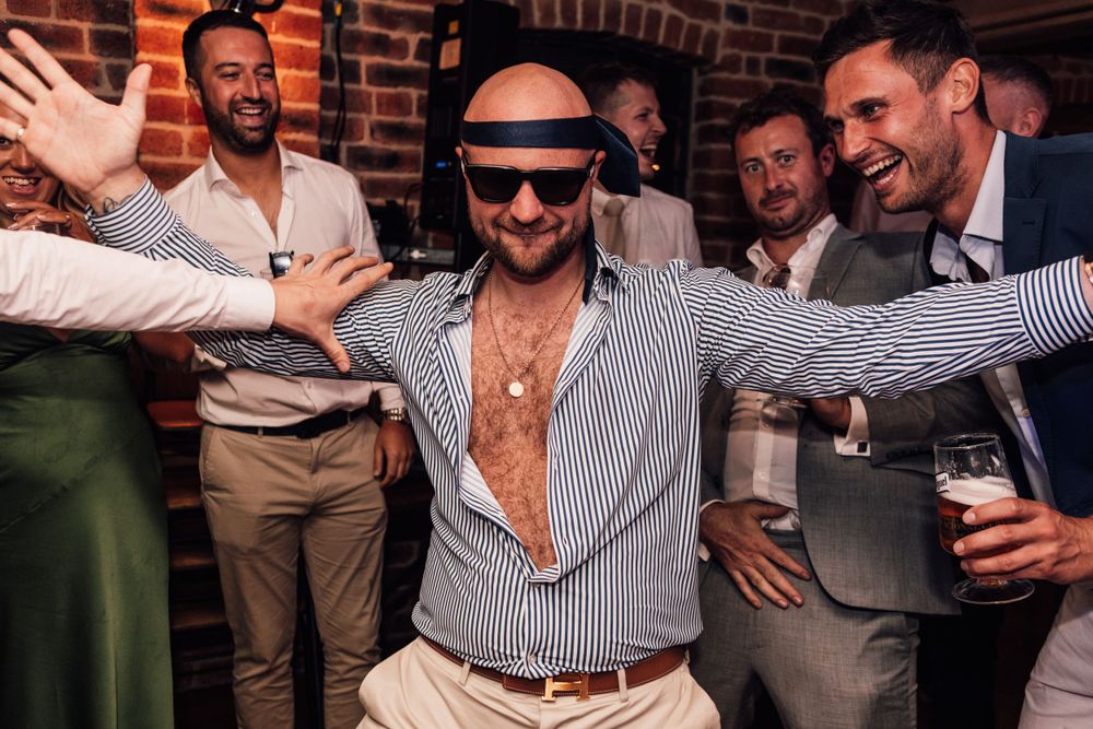 man on dancefloor with tie around head