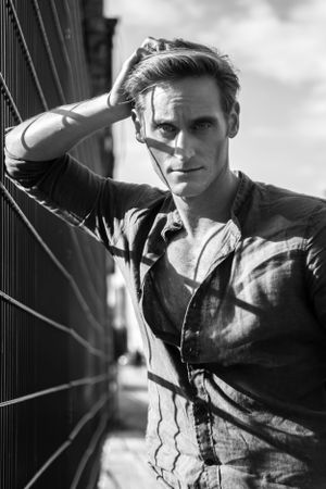 a black and white outdoor portrait of a young man