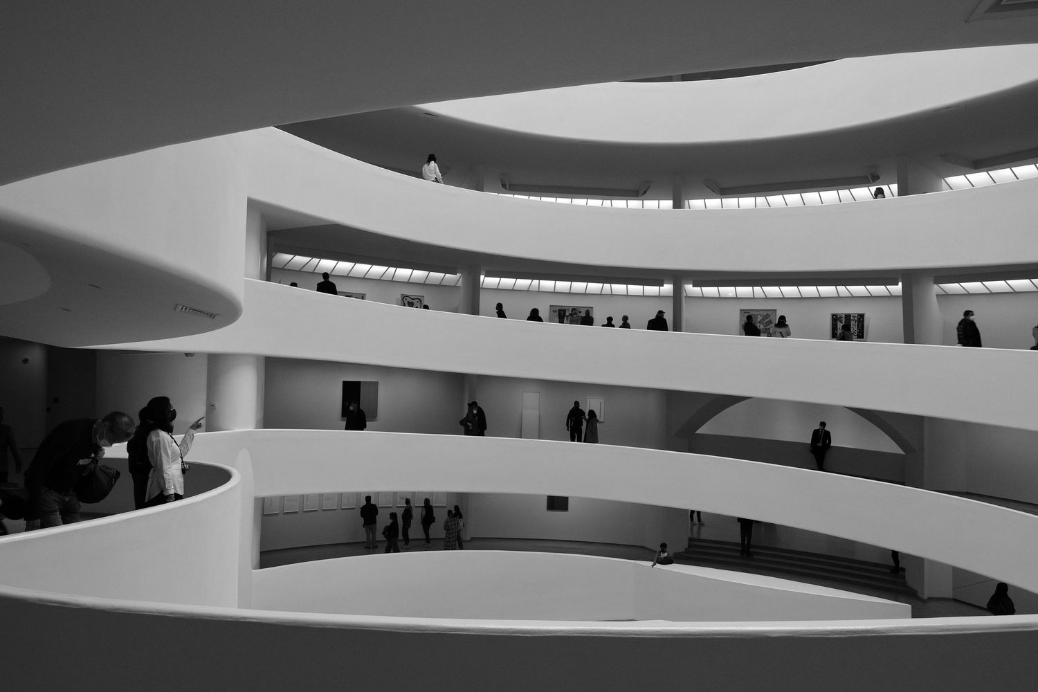 Spiral architecture of Guggenheim Museum interior with curved white balconies.