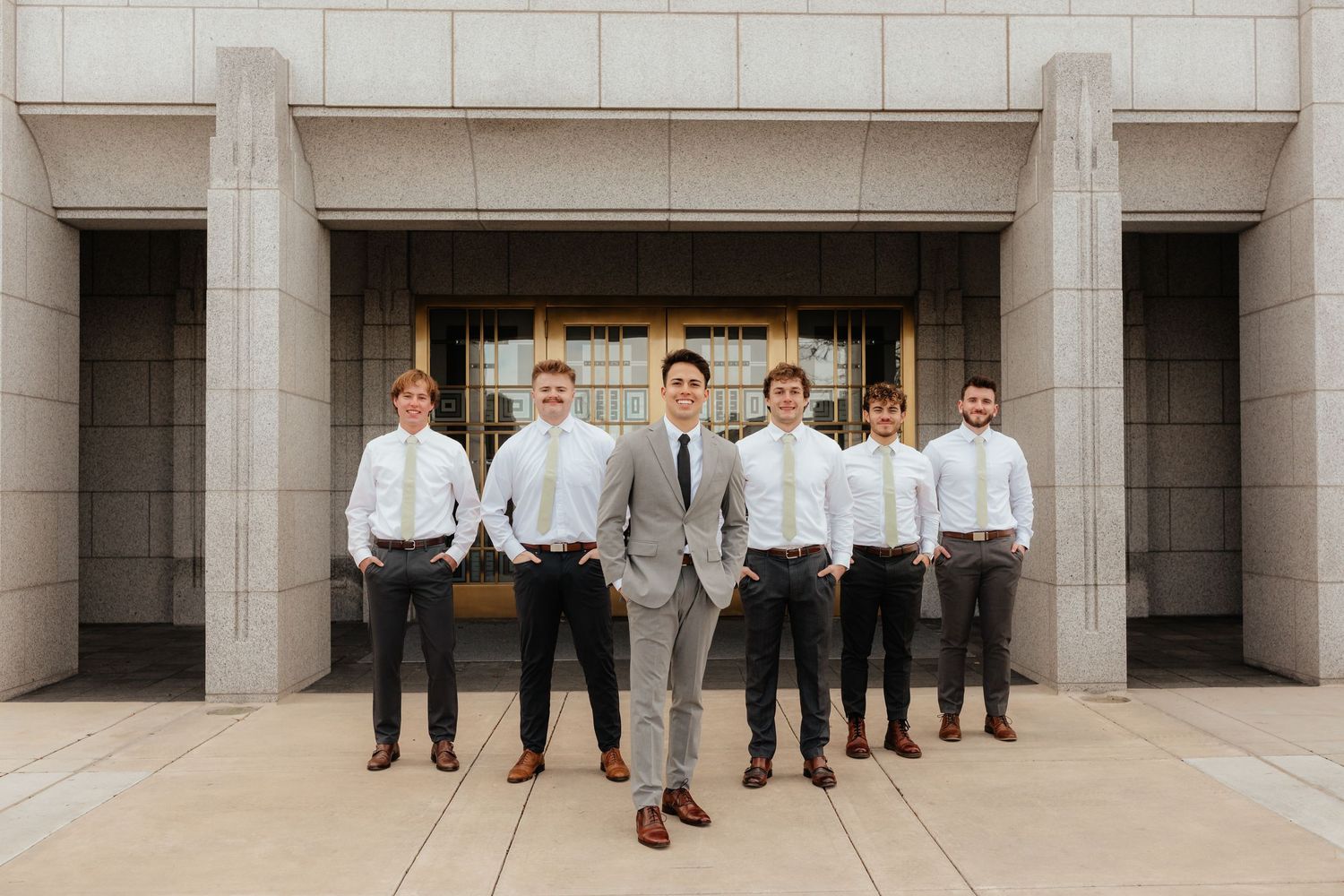Groomsmen posing in a V shape