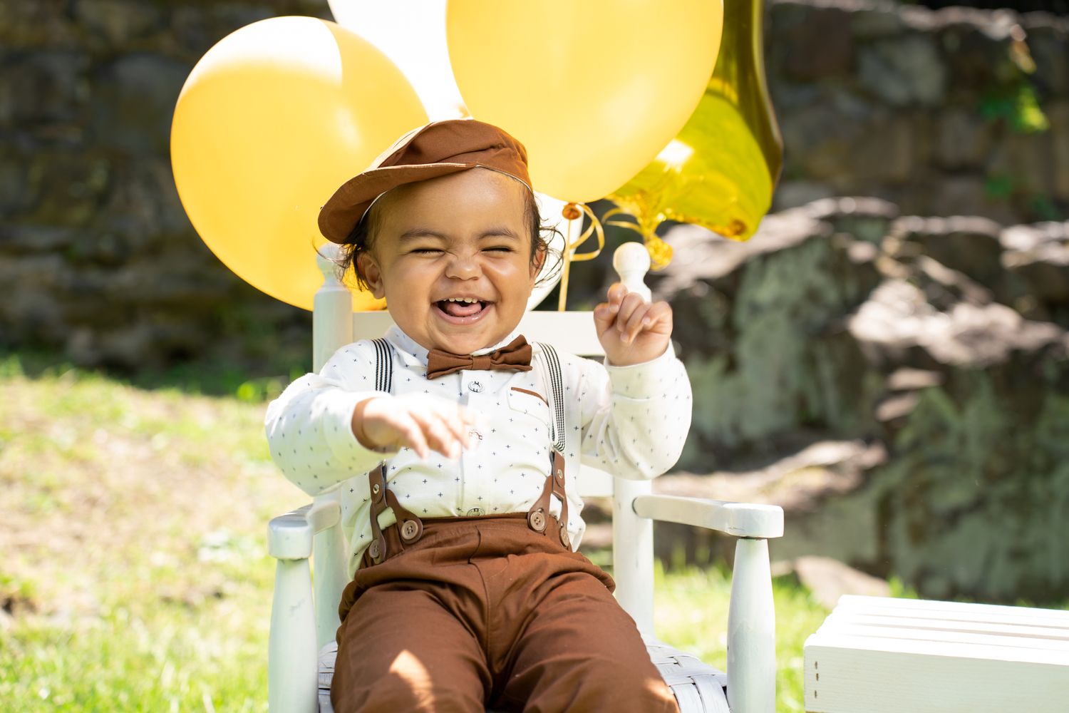 Yellow balloons create a festive backdrop for an outdoor celebration setup.